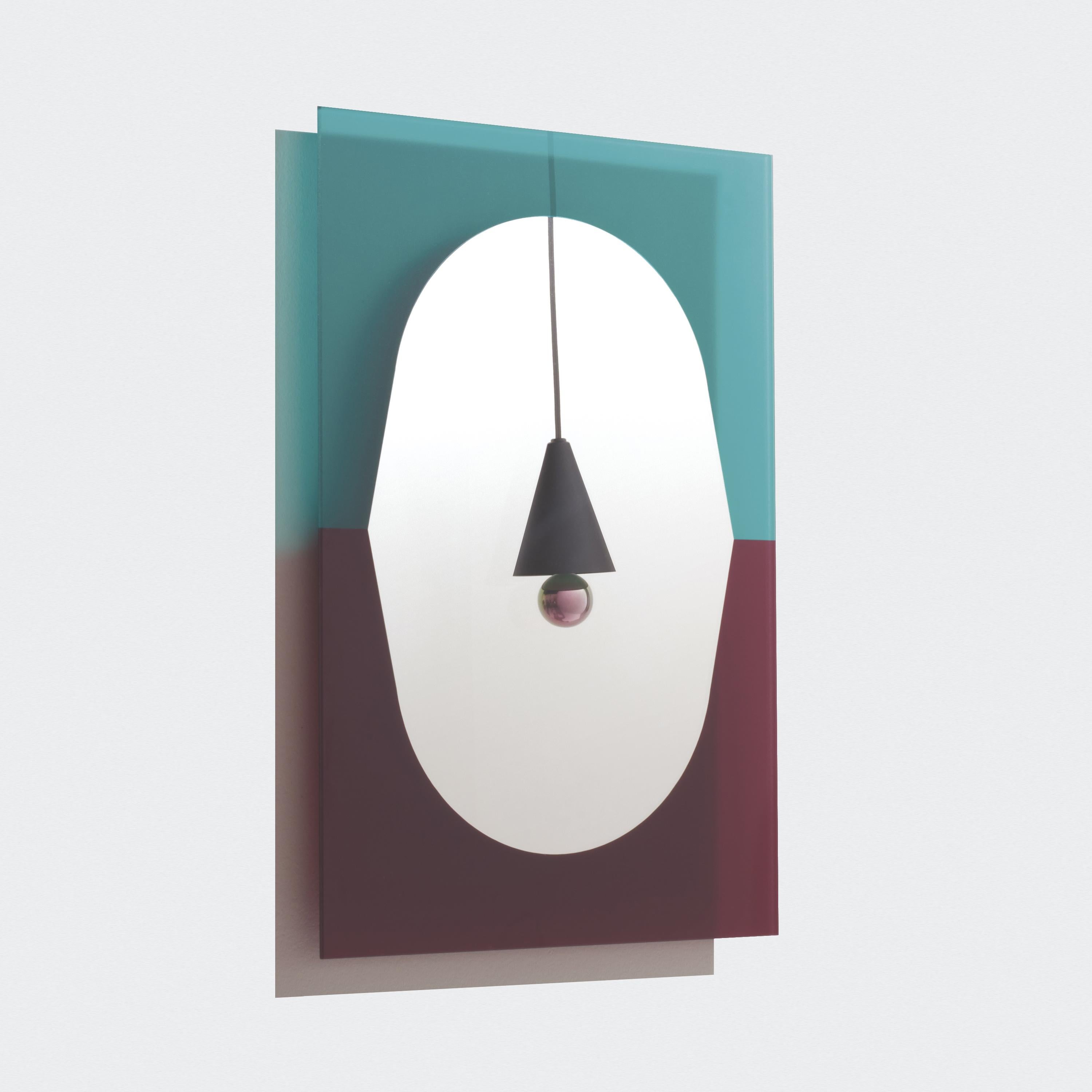 The Small Wander Mirror was inspired by the arts of painting and collage by playfully using shapes and colors to create a bright and dynamic look. The rounded mirror is backed by a translucent colored glass panel, which will cast a subtle halo on