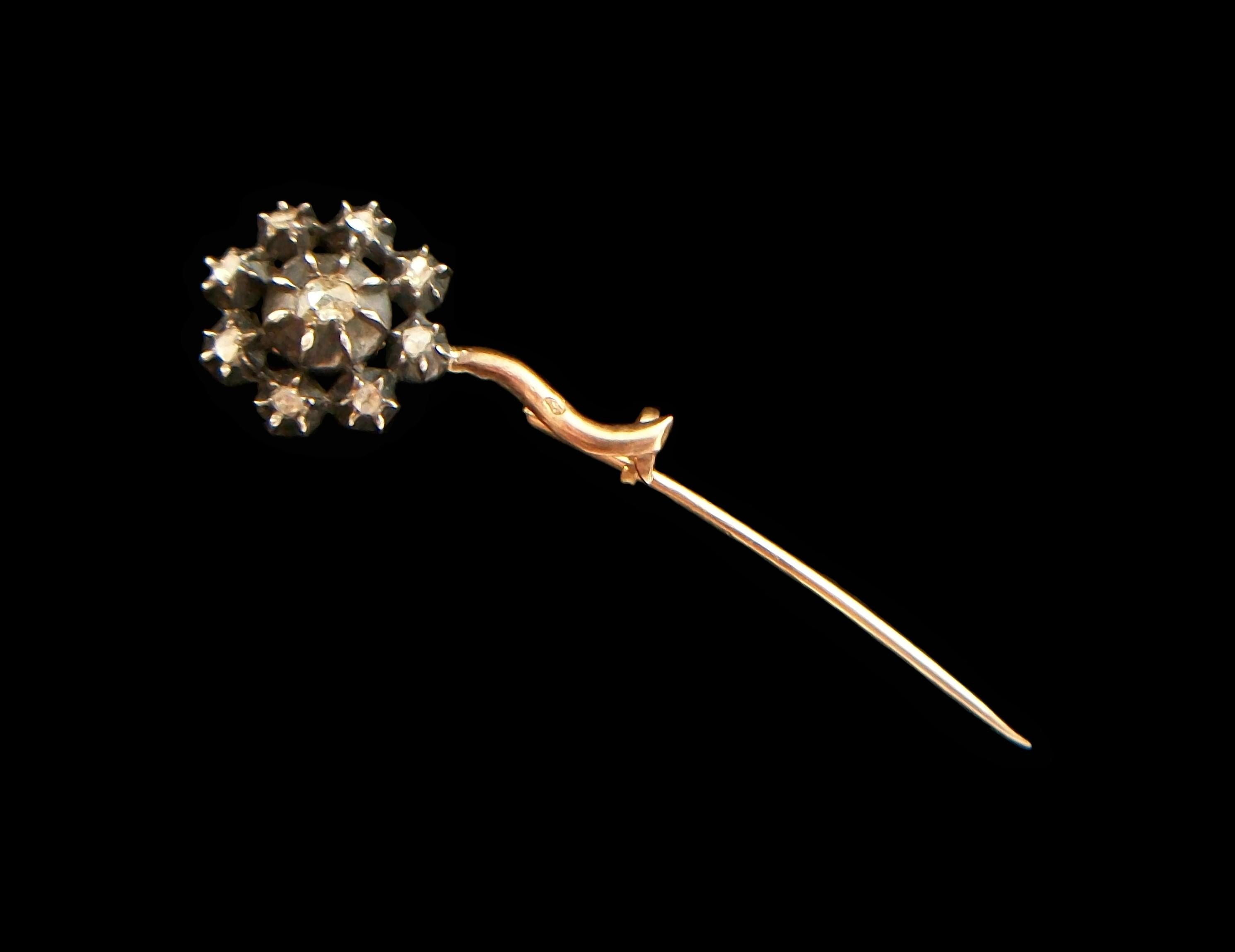 Exceptional petite Georgian era diamond and 18K rose and yellow gold flower brooch - featuring nine old mine cut diamonds in solid silver crimped collet settings to form the flower head (approx. 0.76  Total Carat Weight - the central diamond approx.