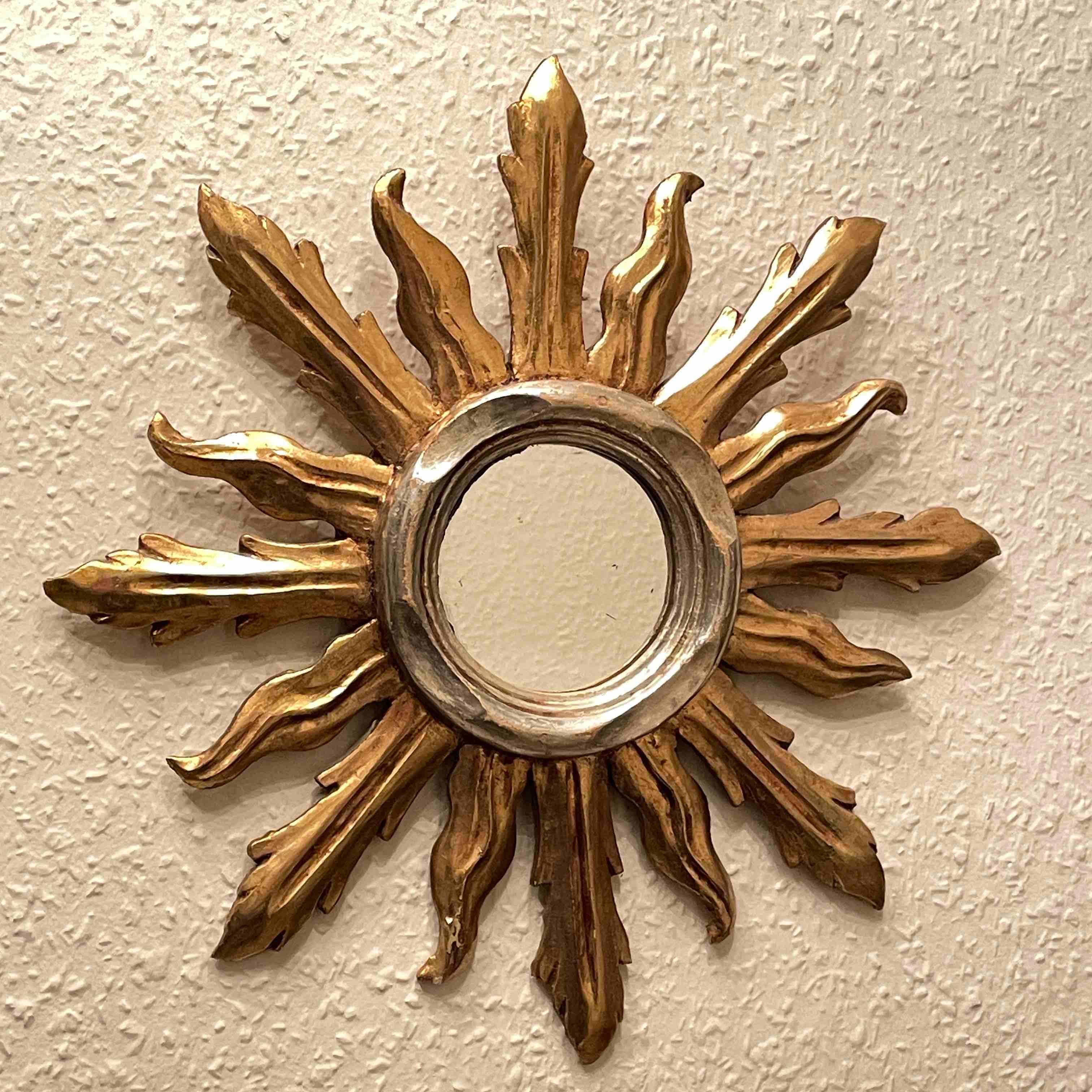 A gorgeous petite starburst mirror. Made of gilded and silvered wood. No chips, no cracks, no repairs. It measures approximate: 13.13