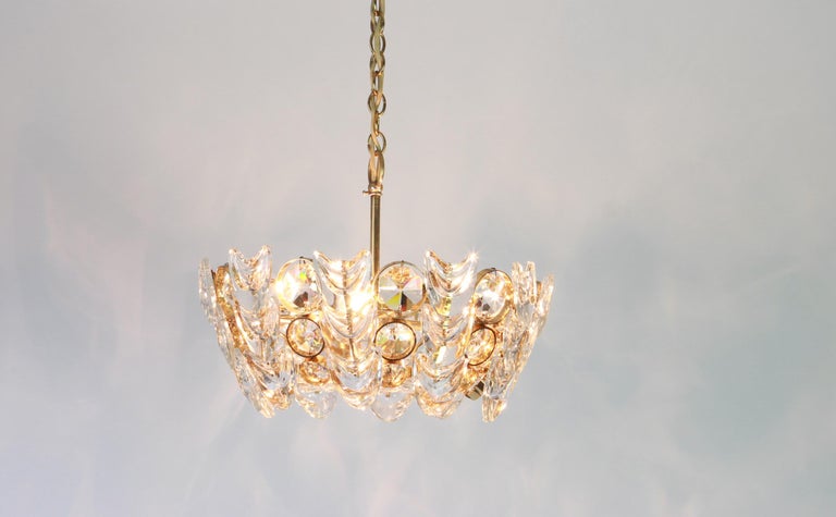 A wonderful petite and high-quality gilded chandelier/pendant light fixture by Palwa (Palme & Walter), Germany, 1970s

It is made of a 24-carat gold-plated brass frame decorated with hundreds of cut crystal glass. The bottom is made of a round cut
