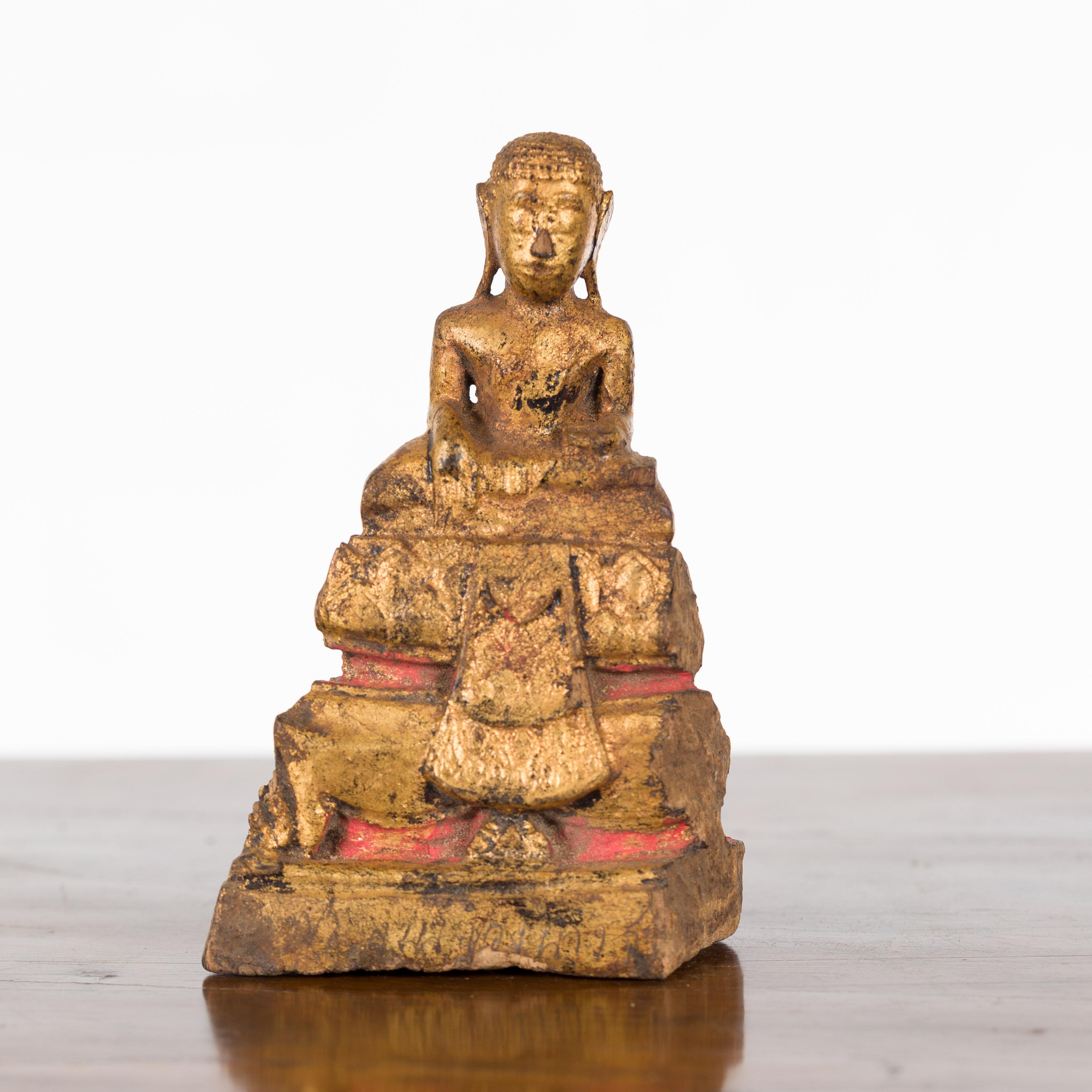 A petite antique Thai giltwood Buddha sculpture from the Ayutthaya period, with the Bhumisparsha Mudra, Calling the Earth to Witness. Created in Thailand during the late Ayutthaya period, this small giltwood sculpture depicts the Buddha seated in