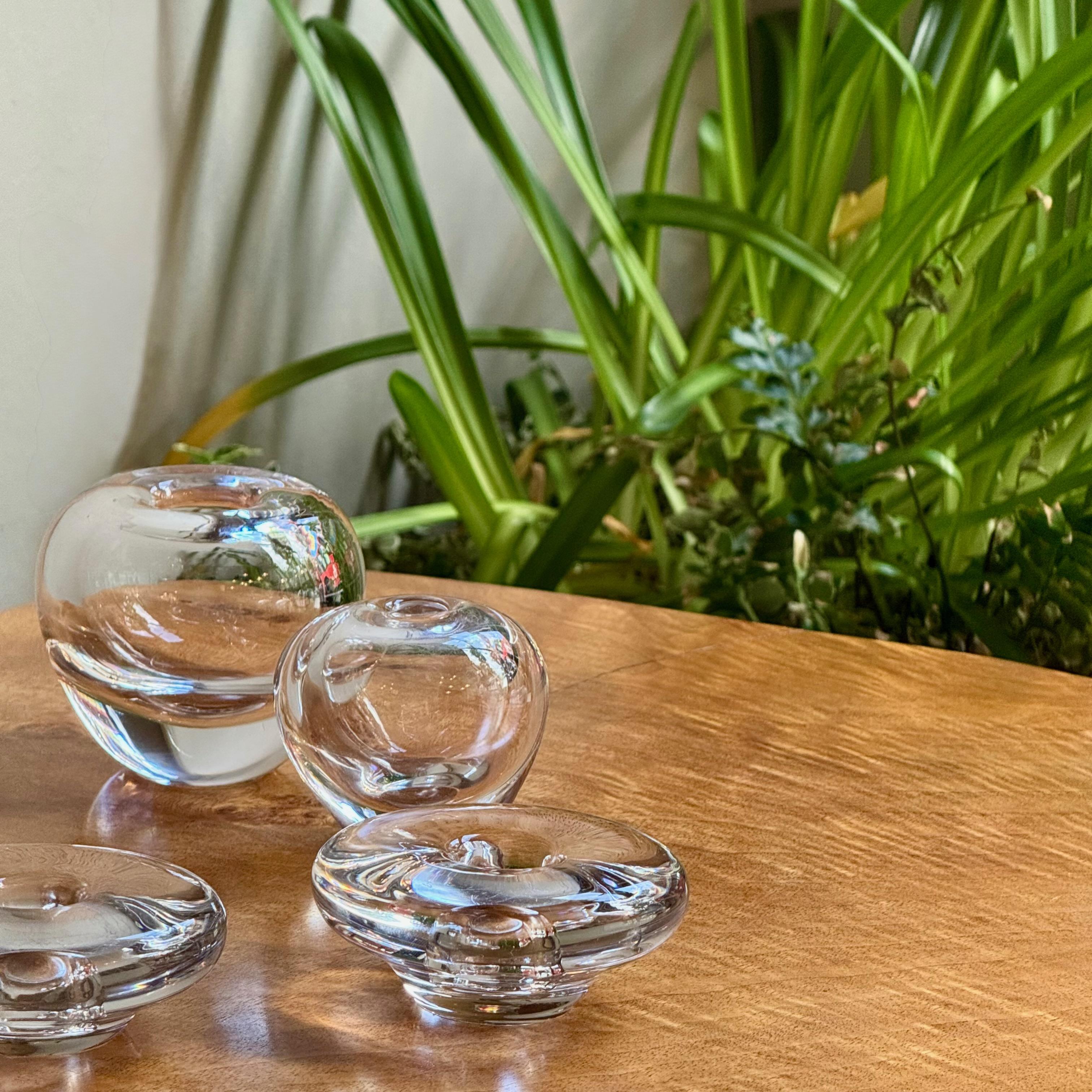 Description:

A petite pair of droplet shaped glass vases made by Swedish glass manufacturer Orrefors during the mid-late 1950s. 

Delicately teardrop shaped but with the reassuring, tactile weight of solid glass. 

This set of small vases pair