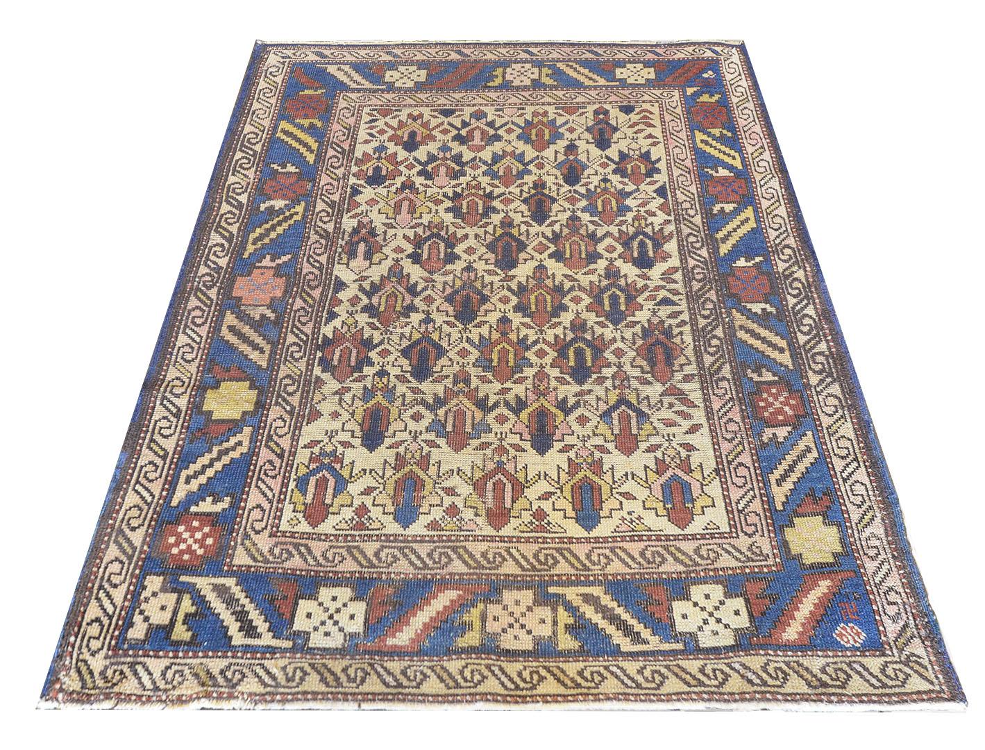 This traditional handwoven Caucasian rug has an ivory field with patterned polychrome palmettes medallions enclosed in a royal blue border with alternating angled geometry and polychrome palmettes nestled between two scrolled ivory borders. A rare