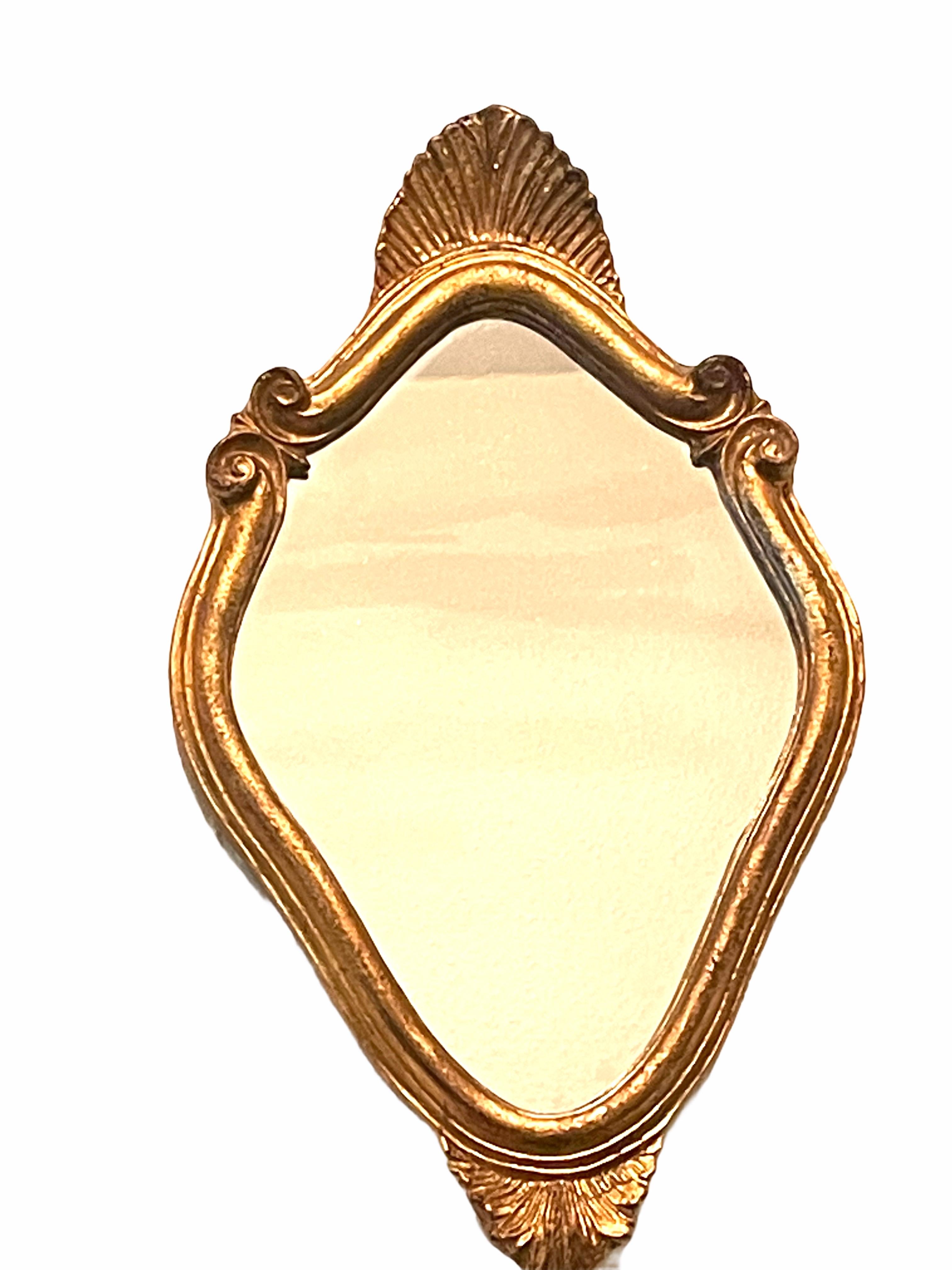 Beautiful Hollywood Regency style toleware mirror. The gilt frame surrounds a glass mirror. Made in Italy, circa 1960s. Beautiful small mirror for any room. Nice addition to any room.