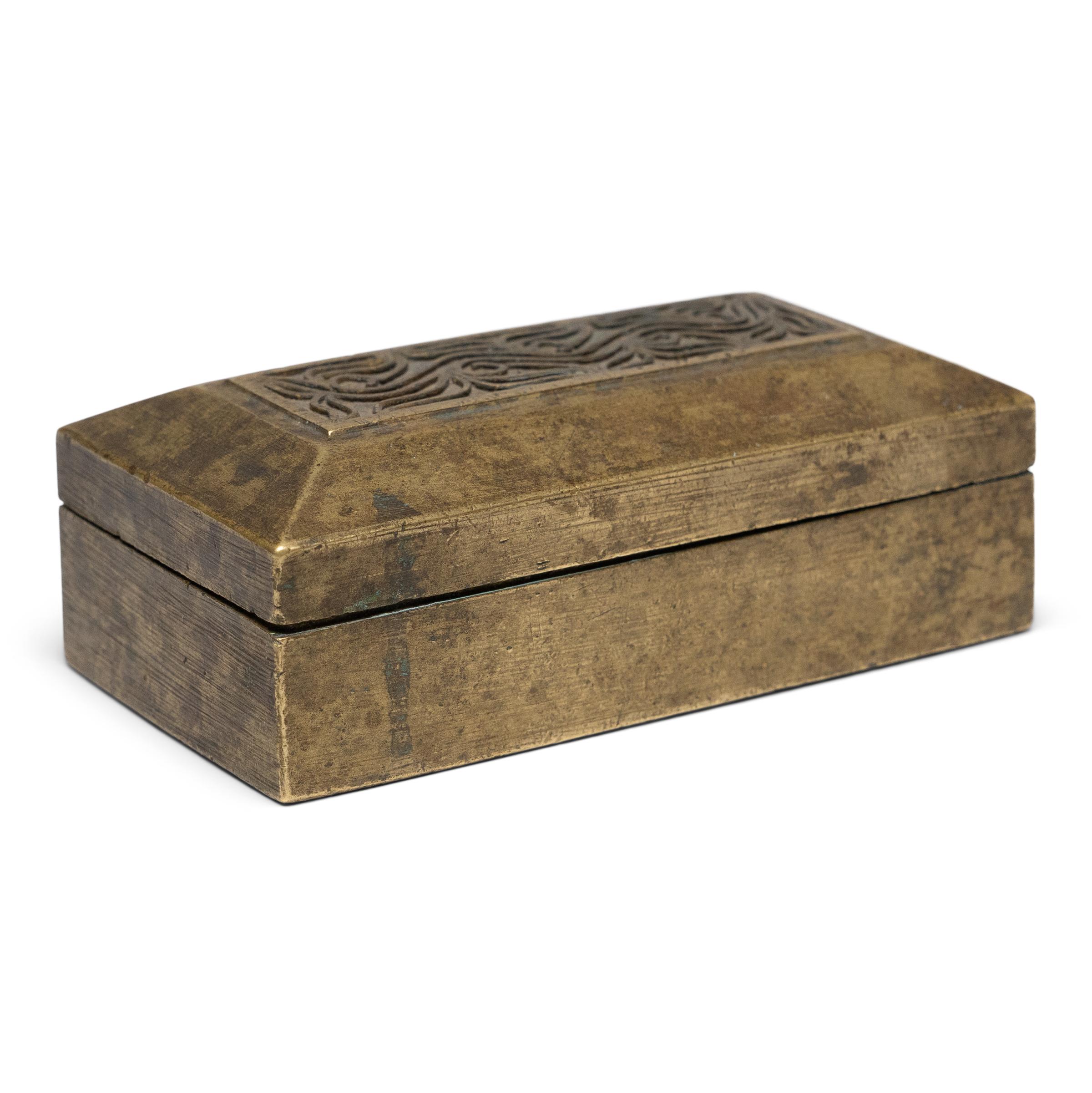 This petite brass box was originally part of an early 20th century betel box set from Indonesia, one of several small containers that held the individual ingredients of a betel quid. A blend of betel leaves, areca nuts, slaked lime, and sometimes
