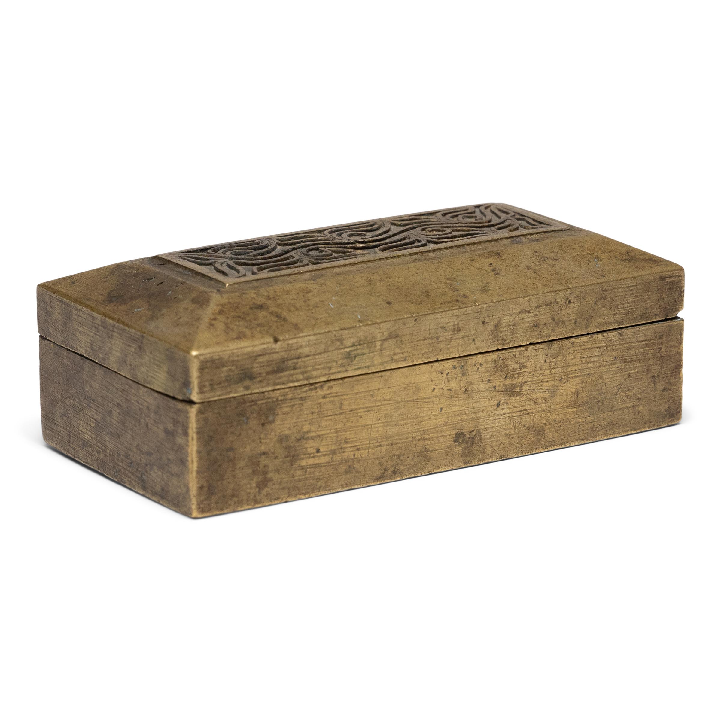 This petite brass box was originally part of an early 20th century betel box set from Indonesia, one of several small containers that held the individual ingredients of a betel quid. A blend of betel leaves, areca nuts, slaked lime, and sometimes