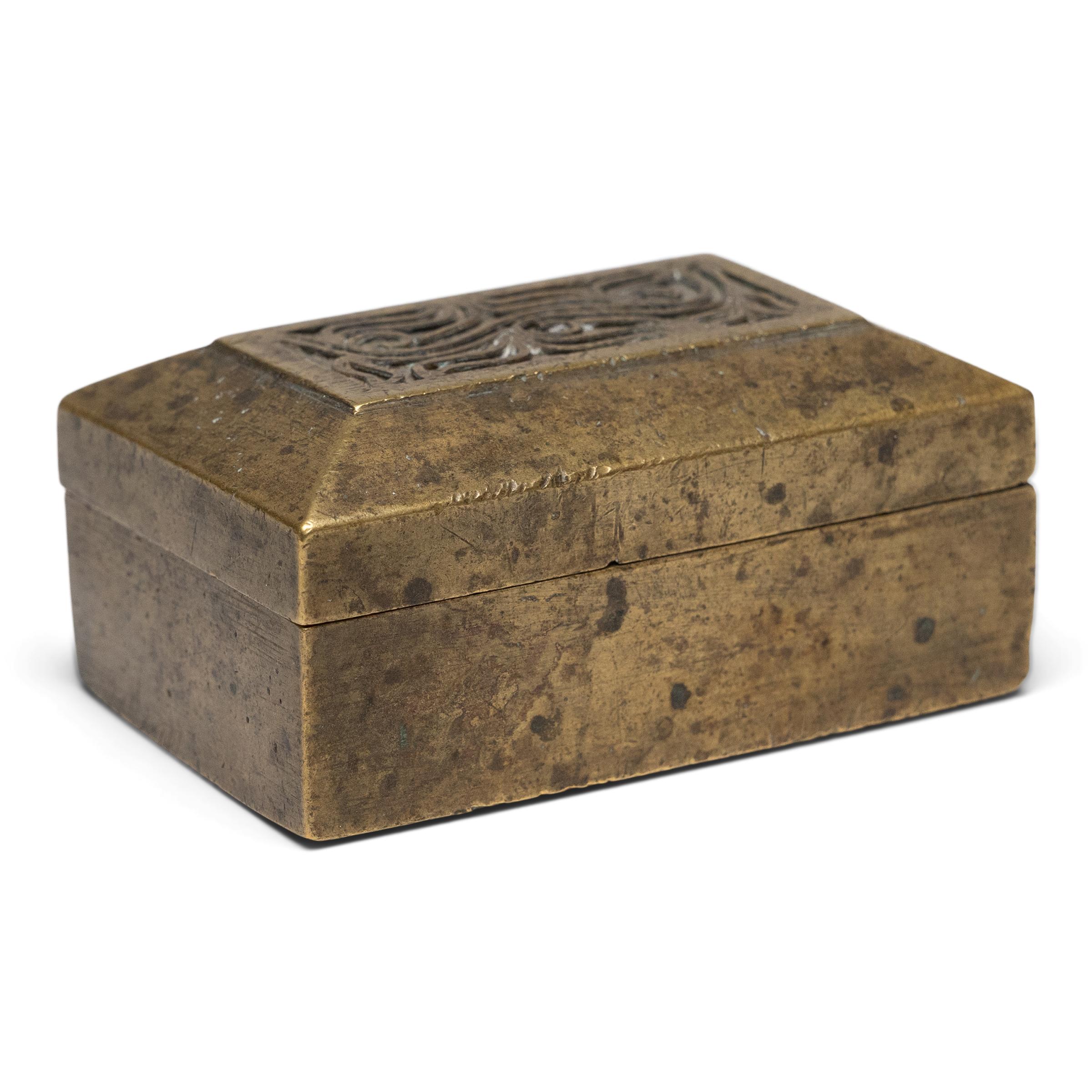 This petite brass box was originally part of an early 20th century betel box set from Indonesia, one of several small containers that held the individual ingredients of a betel quid. A blend of betel leaves, areca nuts, slaked lime, and sometimes