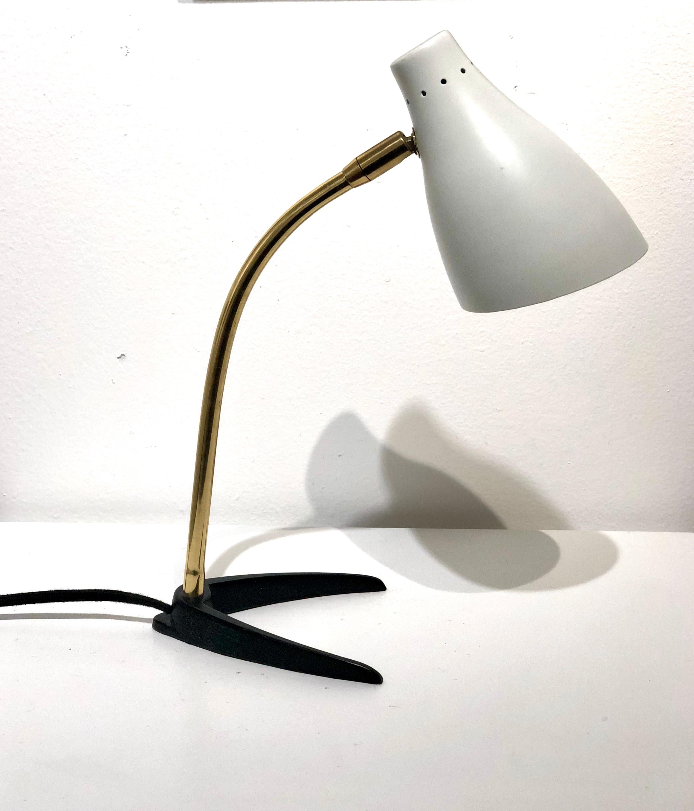 Beautiful Italian design multidirectional desk lamp, white enameled metal shade, with brass polished arm that moves up and down side to side, on iron base freshly rewired new socket totally restored like new condition.