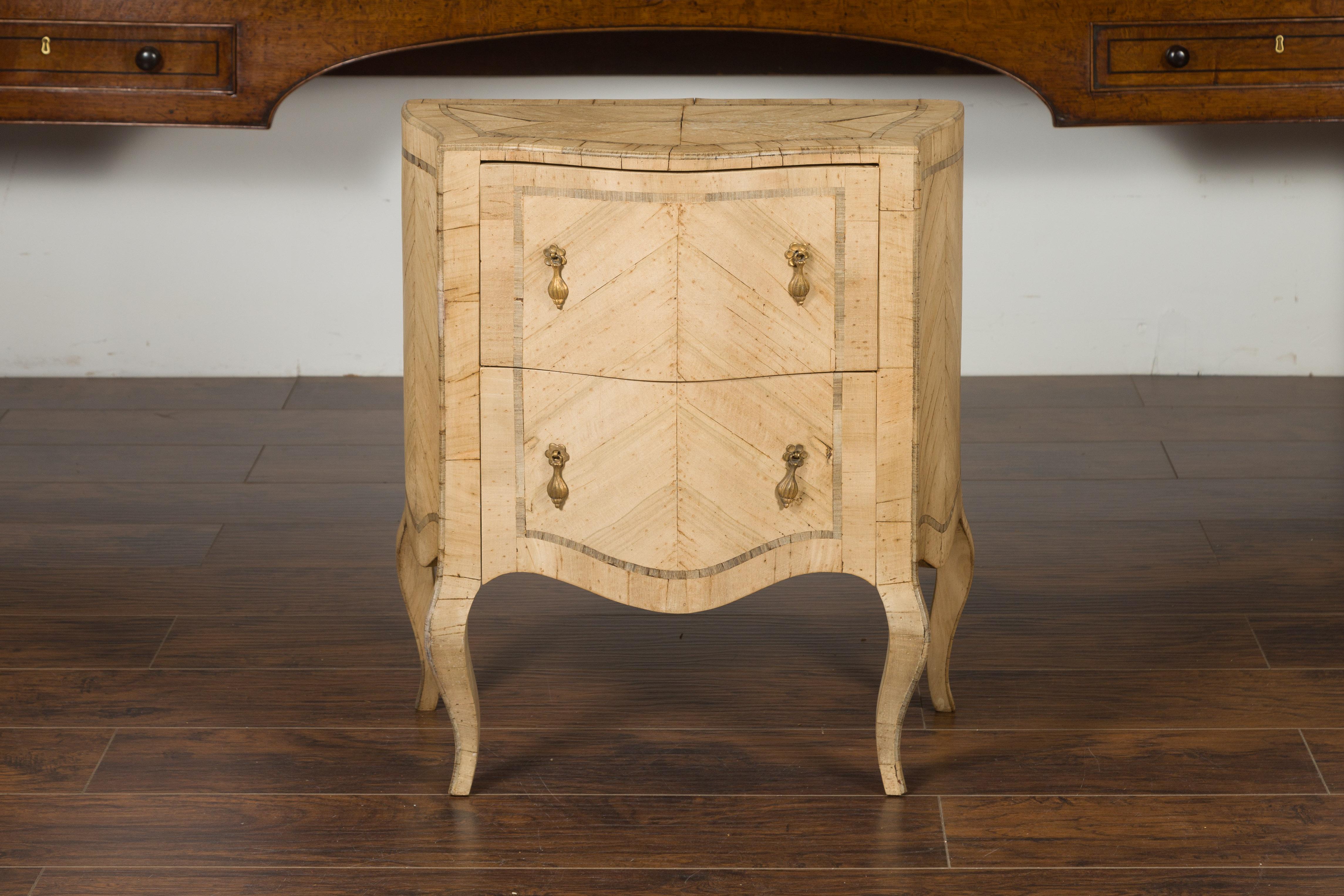 A petite Italian Rococo style walnut commode from the mid-20th century, with butterfly veneer, serpentine accents and cabriole legs. Create in Italy during the midcentury period, this Rococo style walnut commode features a shaped top sitting above