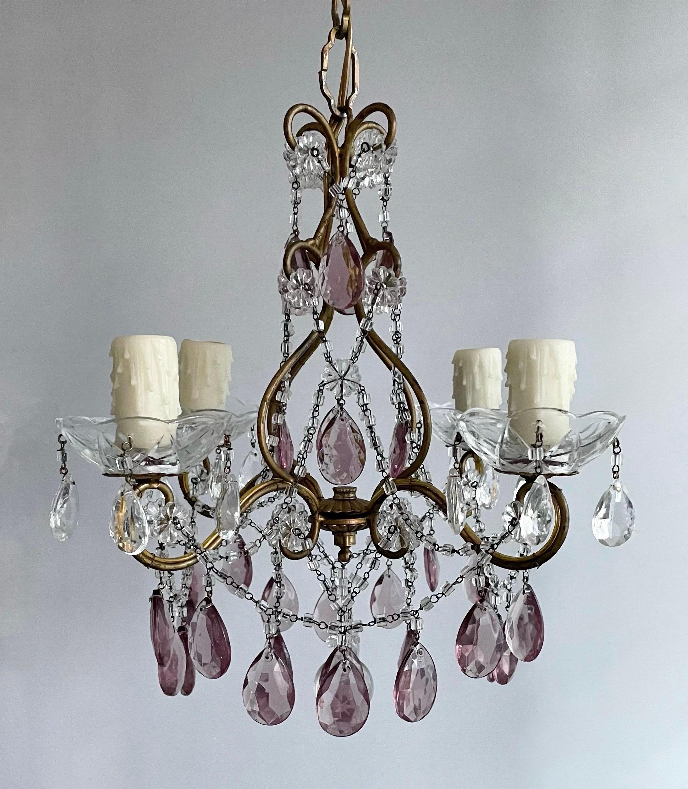 Gorgeous, petite Italian 1940s gilt-iron and crystal chandelier.

The chandelier consists of a delicately scrolled gilded iron frame decorated with crystal beads and light amethyst glass prisms.

The chandelier is wired and in working condition, it