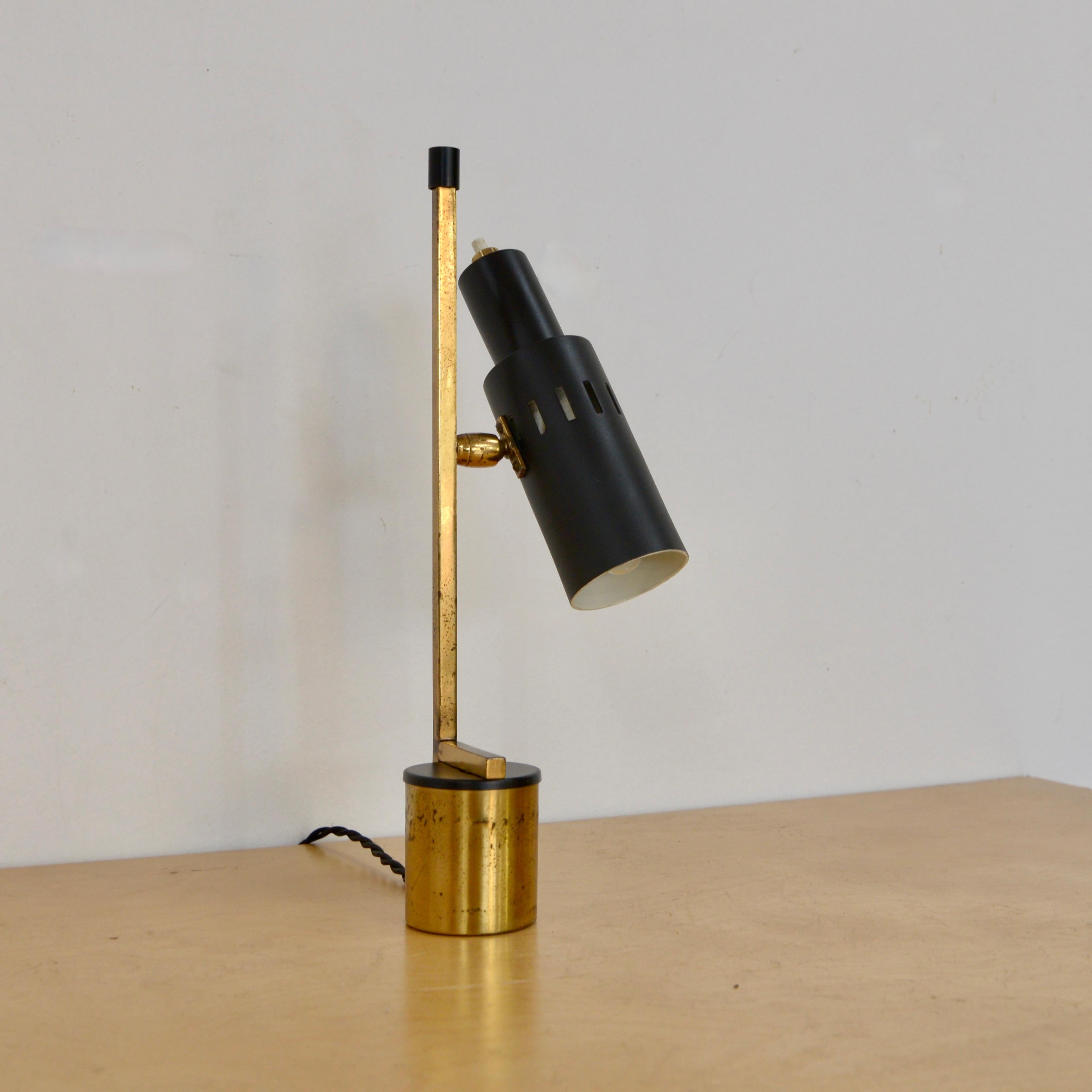 Fantastic petite Mid-Century Modern table lamp from Italy. Naturally aged brass. Restored and rewired for use in the US. Single candelabra based socket. Push switch on shade.

Measurements:
Height 11”
Base 2”
Depth 3”.
 