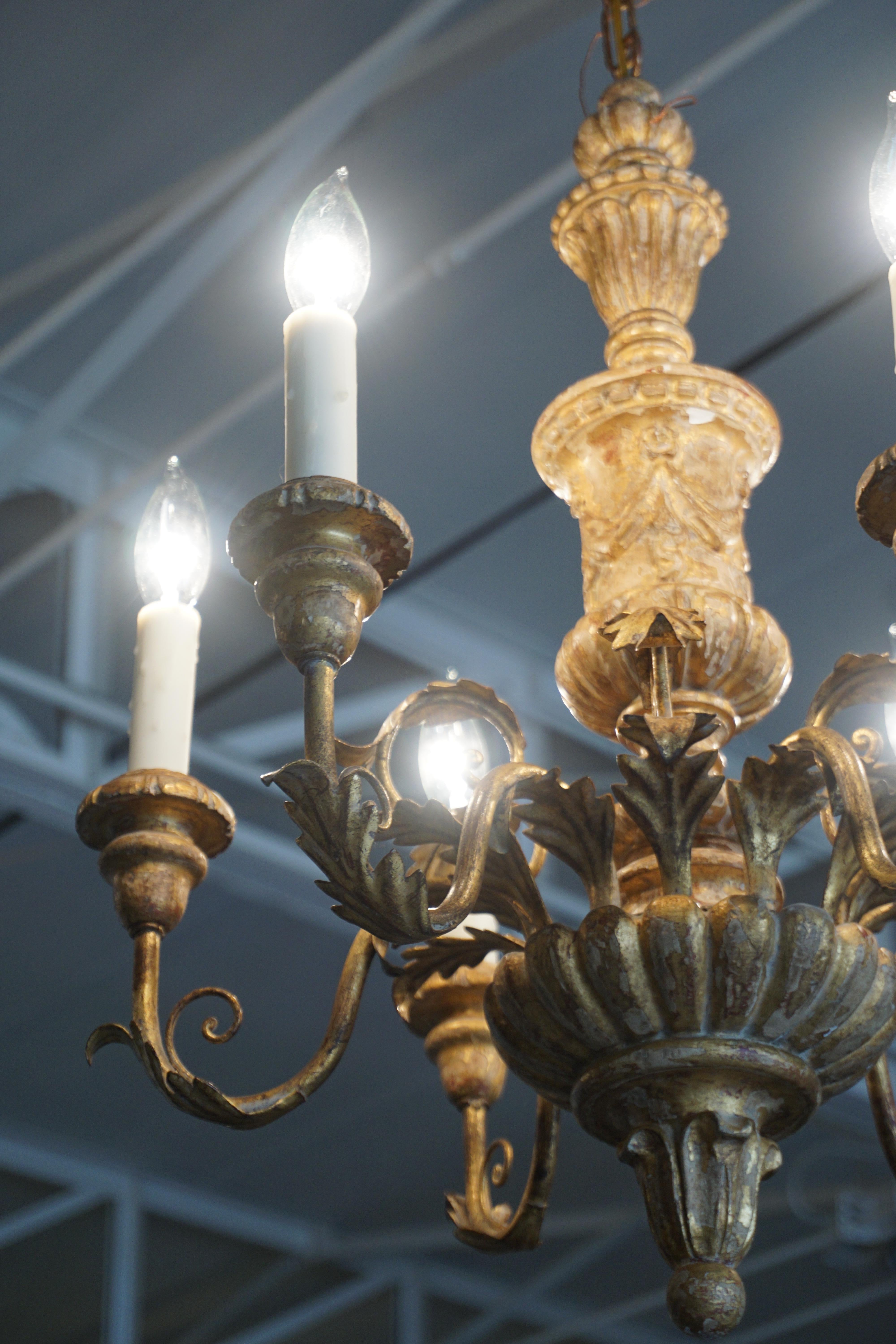 This petite chandelier originates from Italy and is made of giltwood and tole.

Measurements: 24'' H x 19'' W.