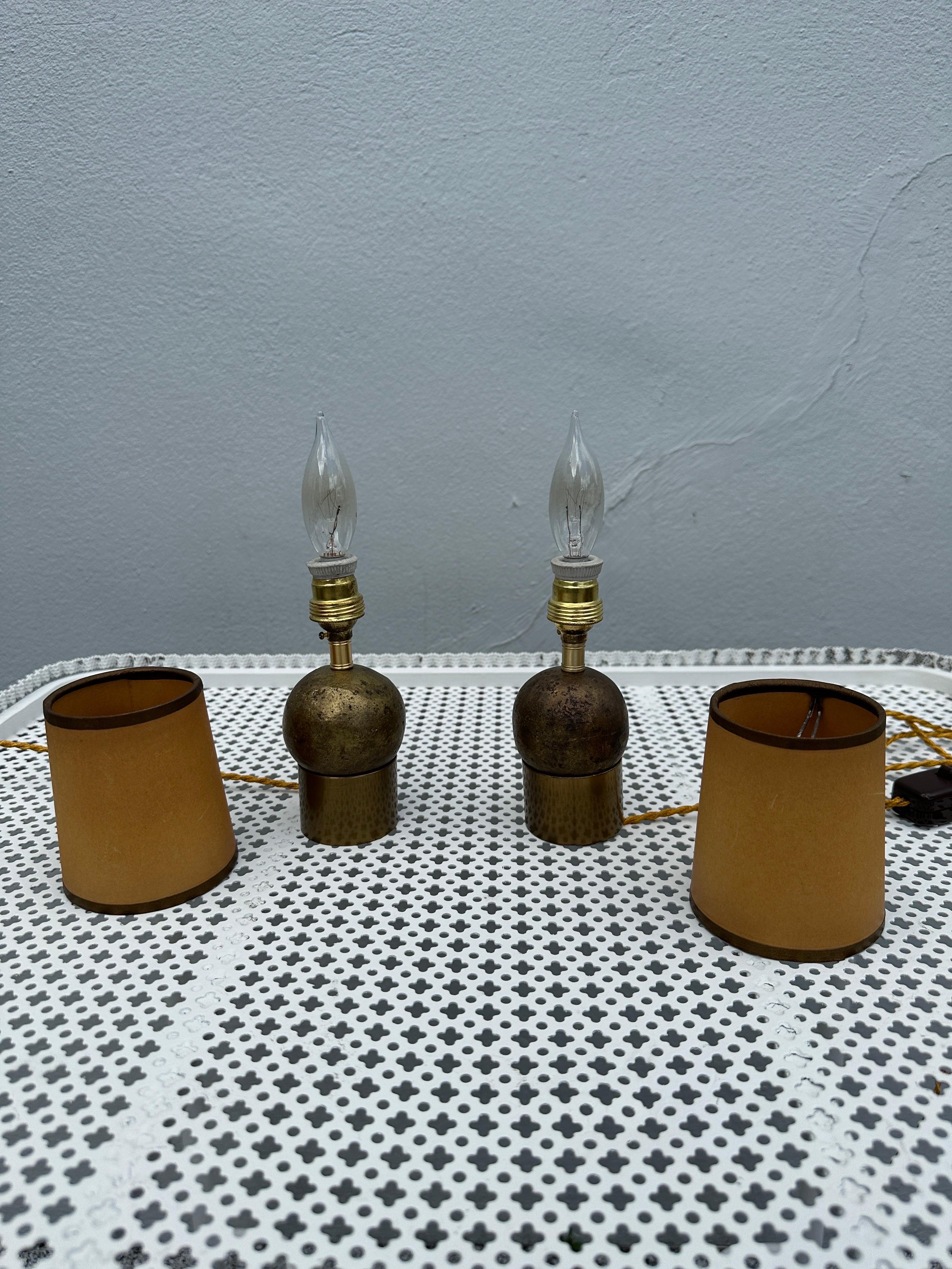 These adorable Brutalist hand-hammered bronze orb lamps sit on a cylinder base, have been newly rewired with top of the line silk twist wire and plug. Vintage paper shades shown are included. Heavy and perfect for any space, e.g. mantel, shelf,