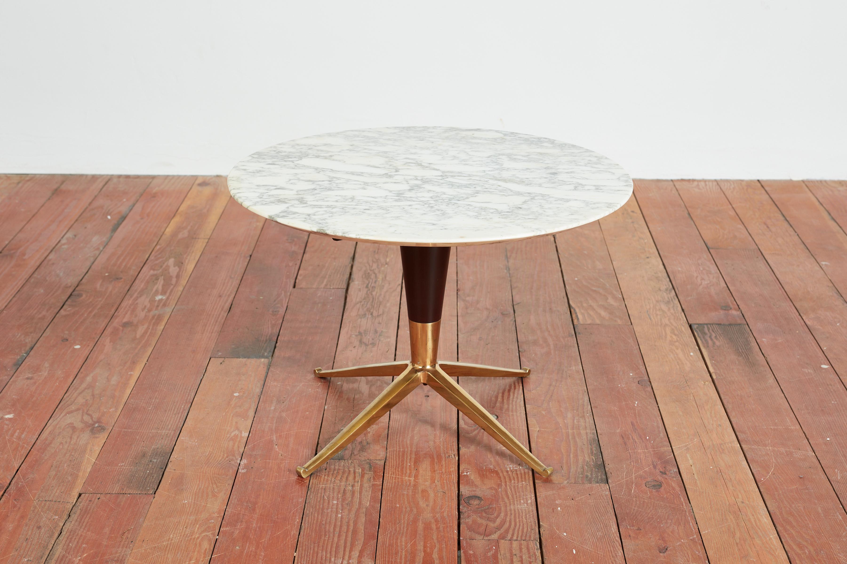 Handsome 1950s Italian table. 
Petite in scale with sculptural solid brass base with fluted wood and gorgeous marble top.