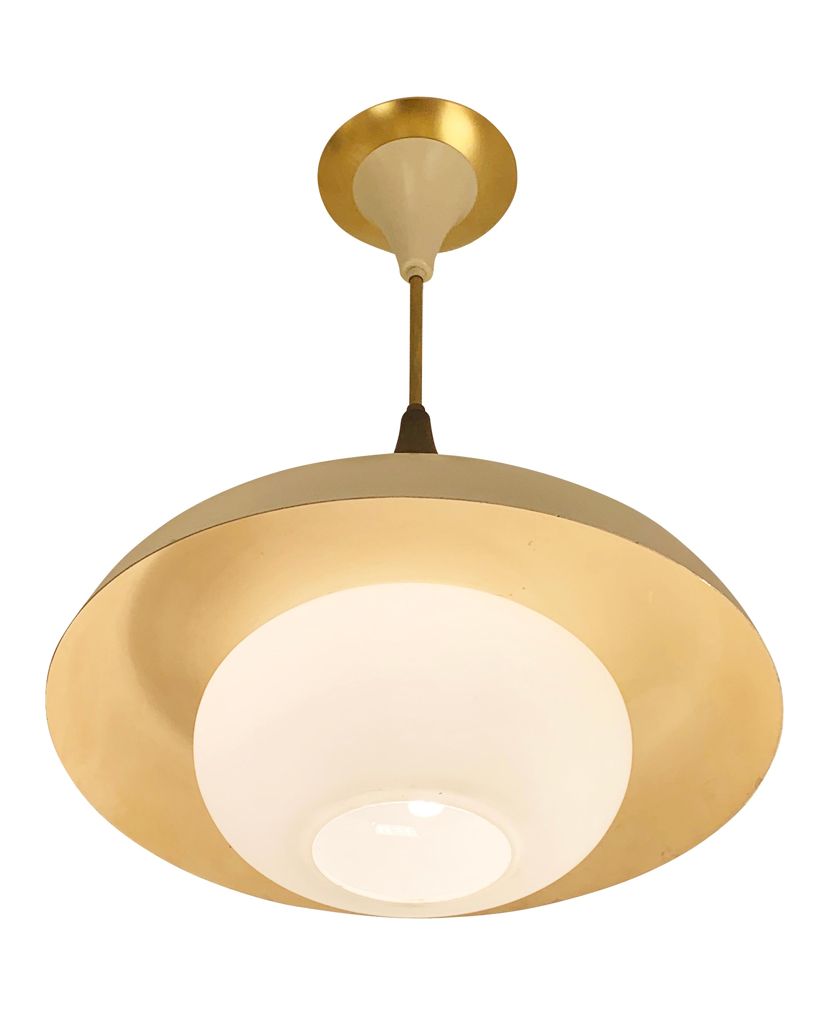 Petite and gracious Italian Mid-Century pendant with a frosted glass diffuser and off-white lacquered framing. Brass details. Height of stem can be adjusted as needed.

Condition: Excellent vintage condition, minor wear consistent with age and