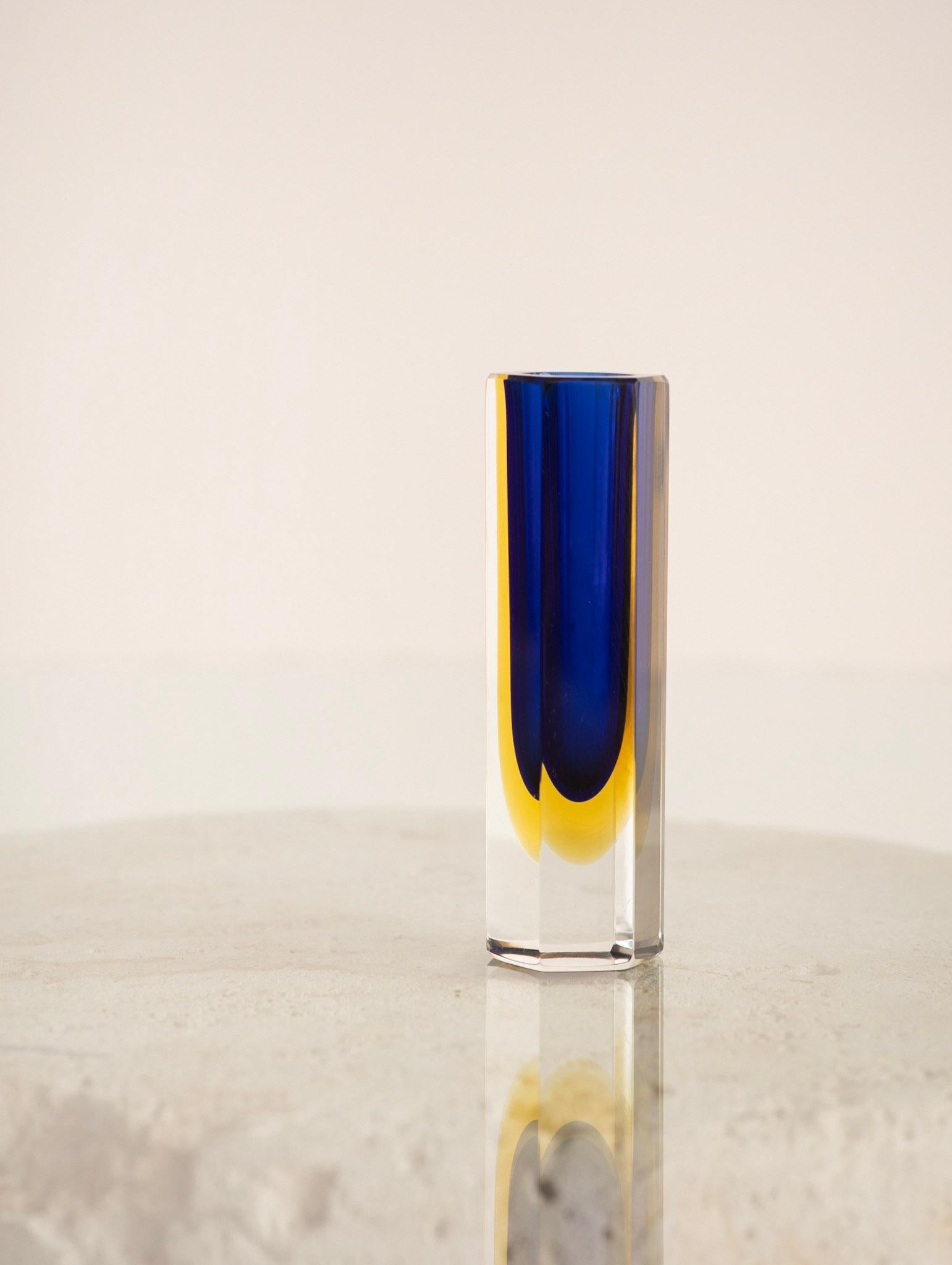 Mid century Murano sommerso glass vase. Petite in size. Cut facets show inner cobalt and yellow colors. Neck opening measures 1.25”.

Sommerso is the glassmaking technique of creating two or more layers of contrasting glass without the colors