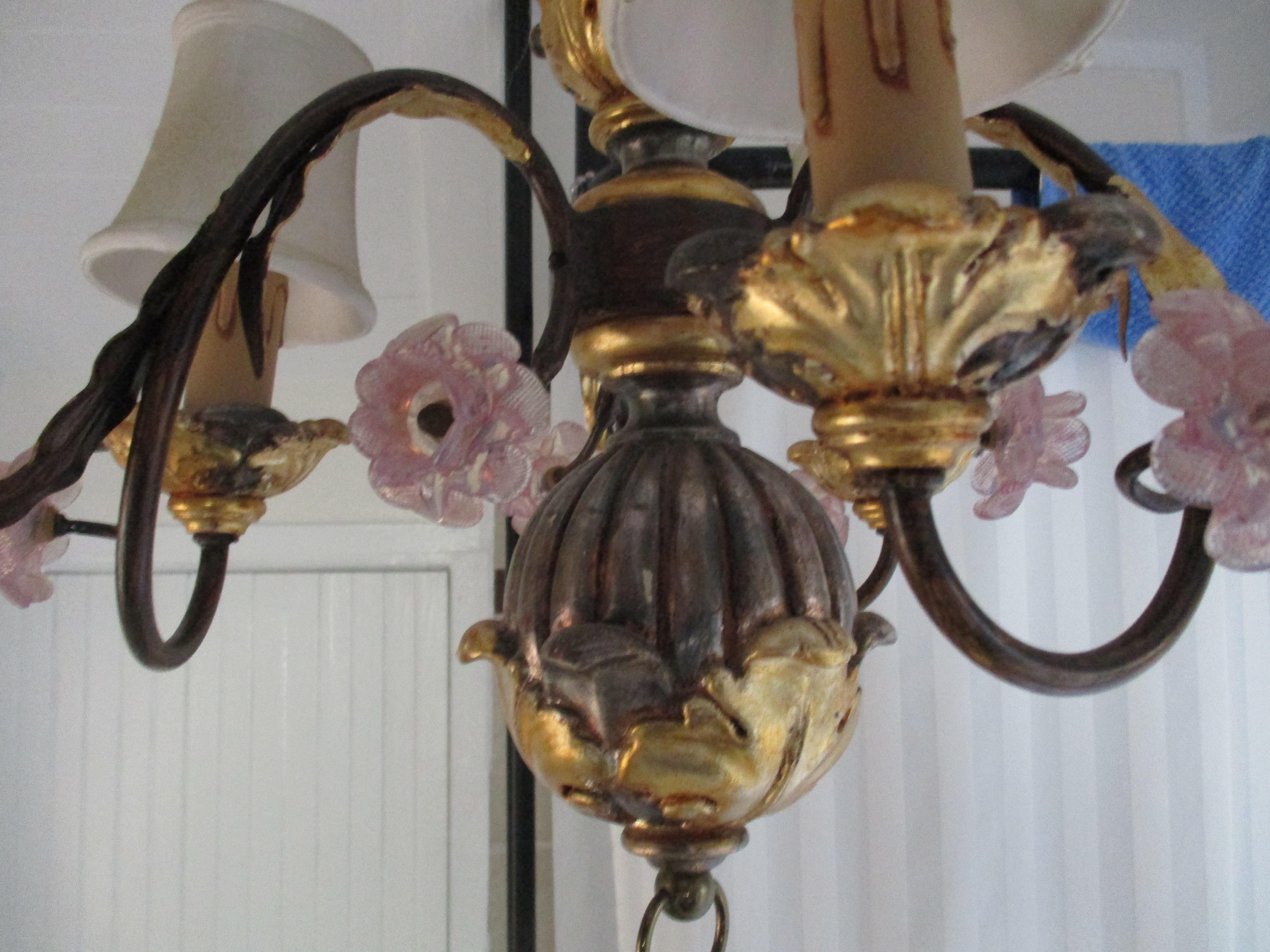 1940s Italian tole and painted chandelier with outward scrolling candle arms wrapped in gilt acanthus leaves and delicate pink Murano flowers.