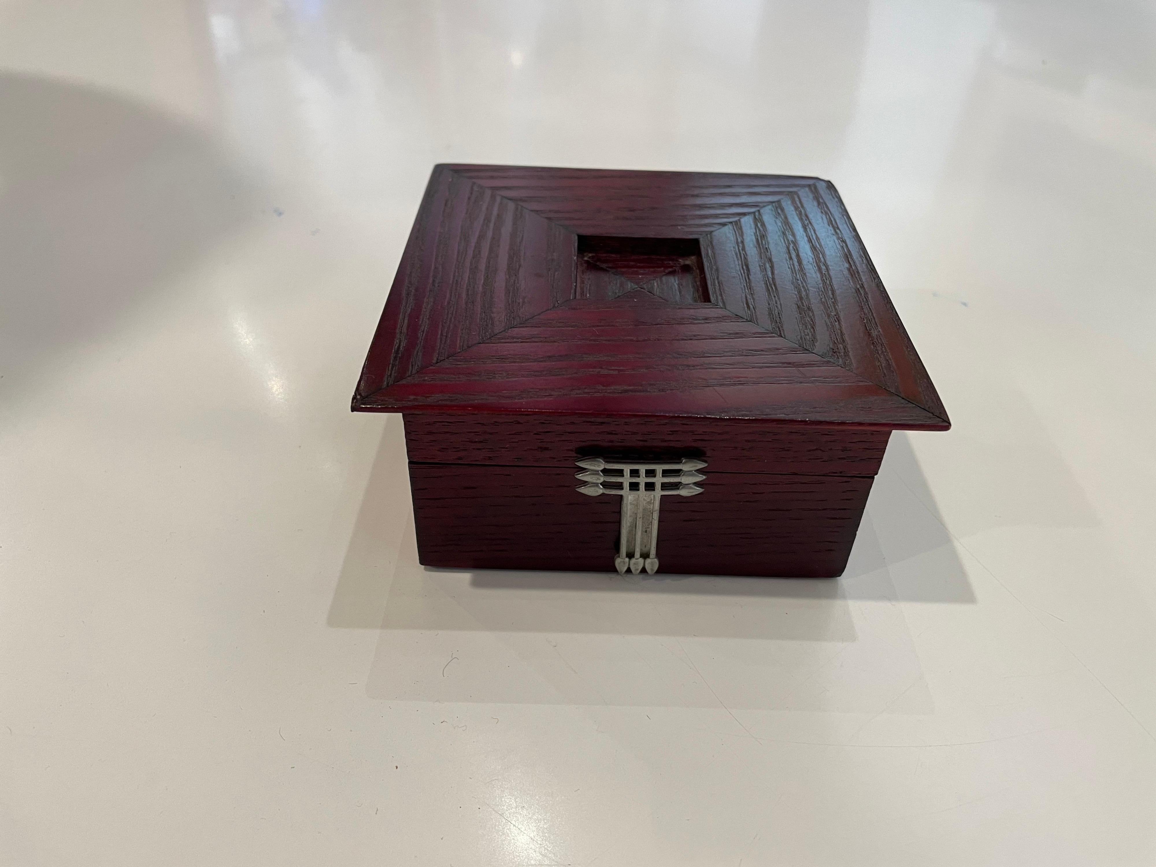 This simple elegant petite jewelry box part of the Charles Rennie Mackintosh collection, solid stain oak with pewter decorative accents., Made in Scotland by Carrick.