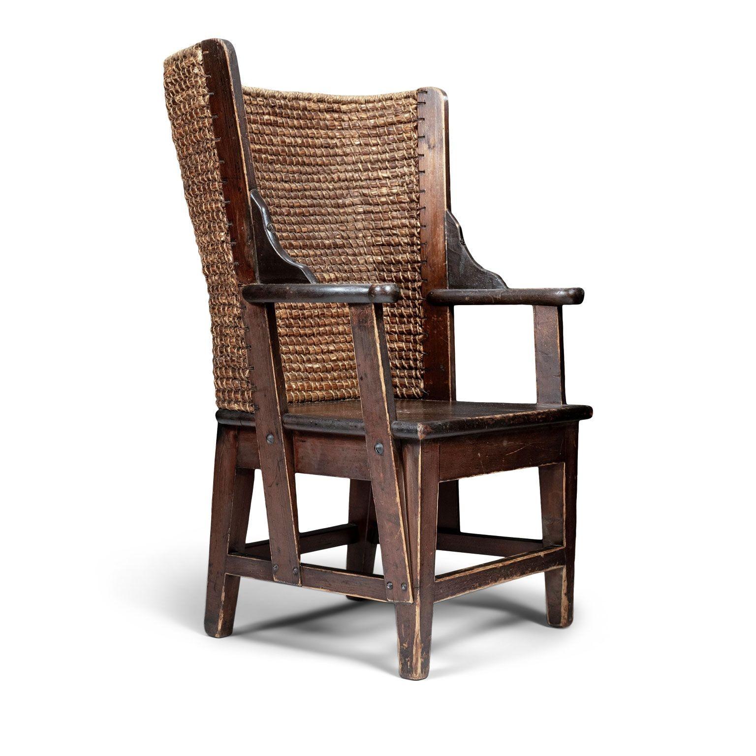 Petite jute and pine Scottish Orkney chair, dating to late 19th or early 20th century. Open arms, hand-woven jute back, solid seat and raised on tapered square supports joined by stretchers. Perfectly sized for fireside seating or a child.