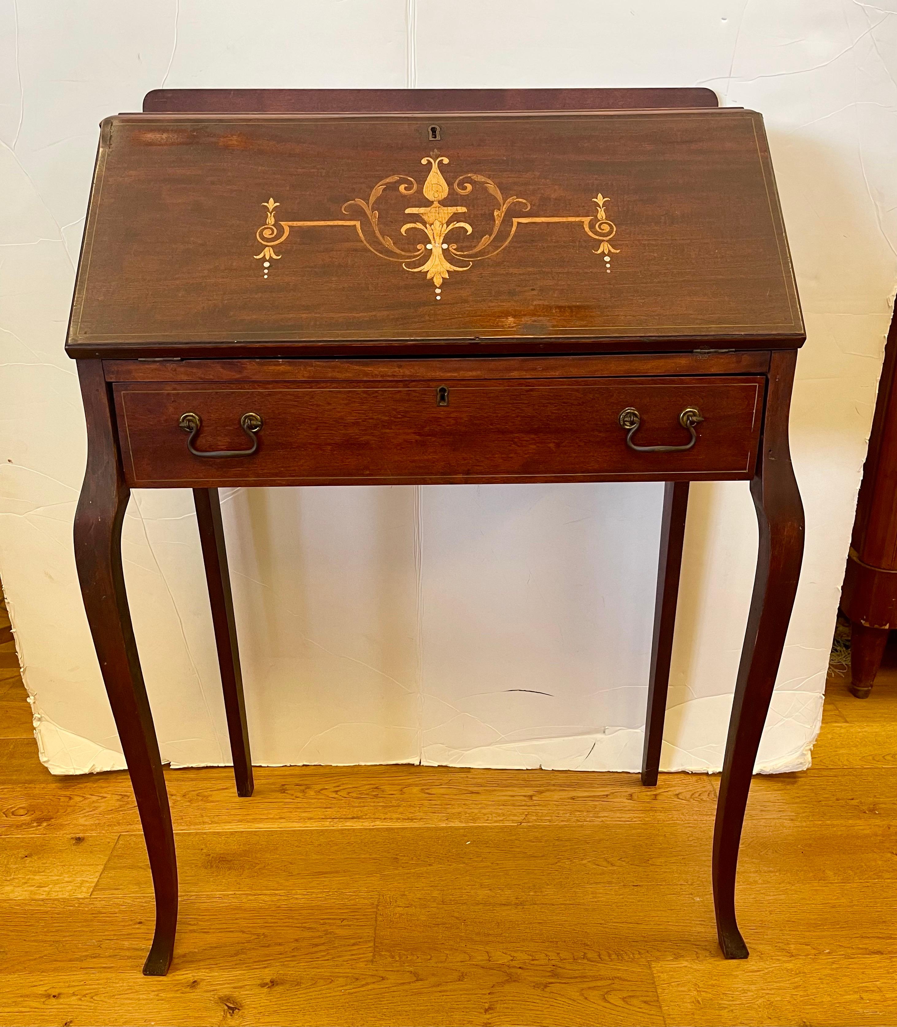 Stunning antique slant front desk with secretary feature when top is open.
Dimensions above are when top s closed.  There is some age appropriate wear as shown in the pictures but the piece is magnificent with lines to die for. Yet, it is the inlay