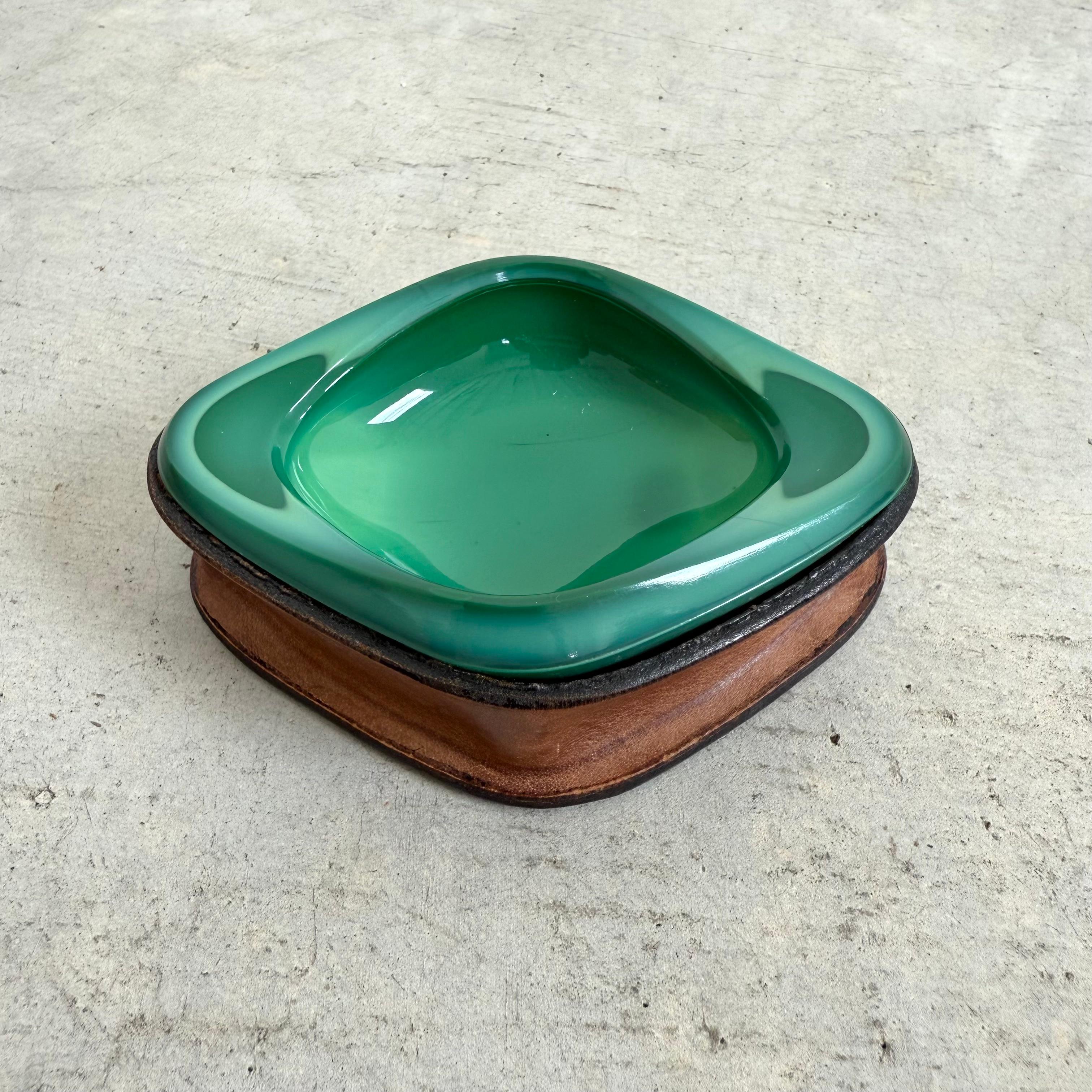 Beautiful vintage emerald green ceramic ashtray set atop a brown leather-wrapped base. Great sculptural and functional piece. 

Located at our Los Angeles showroom. 