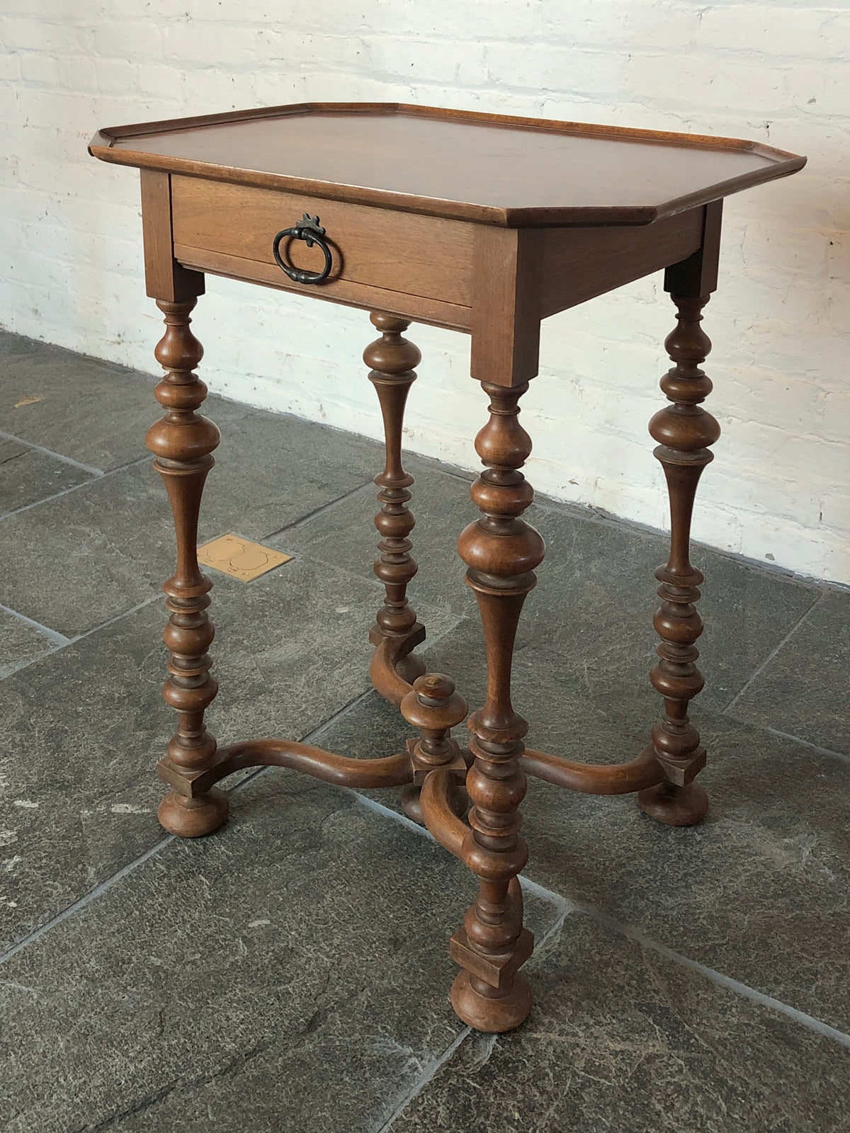 Delicate, small Louis XIII center or end table.
The tray-top above one frieze drawer supported by intricately turned legs joined by wavy X-stretcher, adorned by a middle finial.
Our pieces are left in lived-in condition, pending our custom