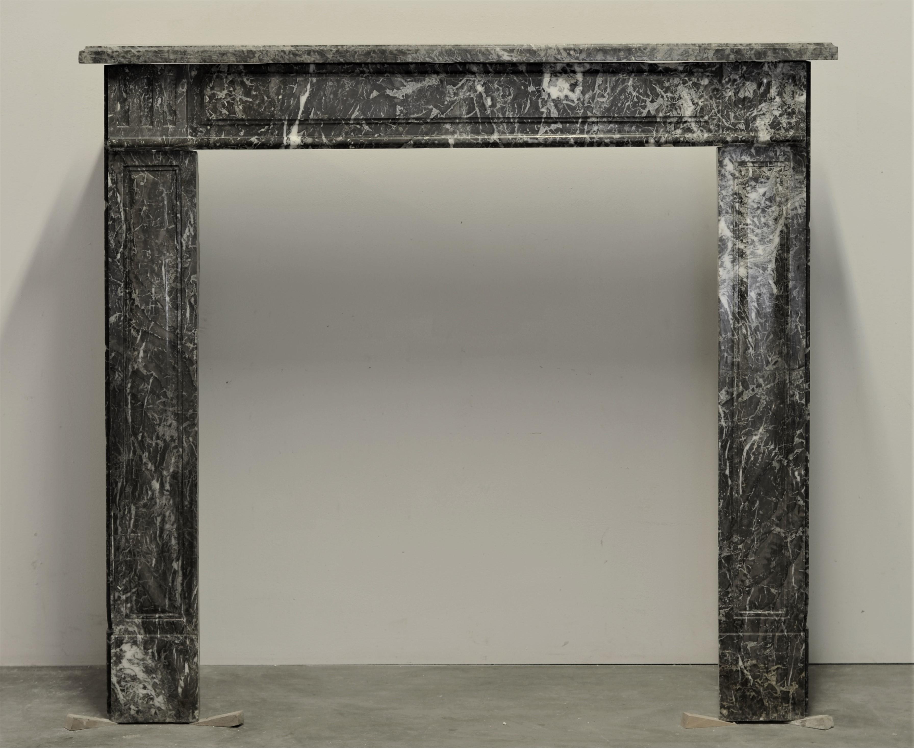 Nice and small, paneled Louis XVI fireplace mantel from France.
This mantel is executed in Saint Anne marble, this marble has a lovely soft grey and white tone. 

Mantel has some minor restoration, sides appear to be non original.
Comes with