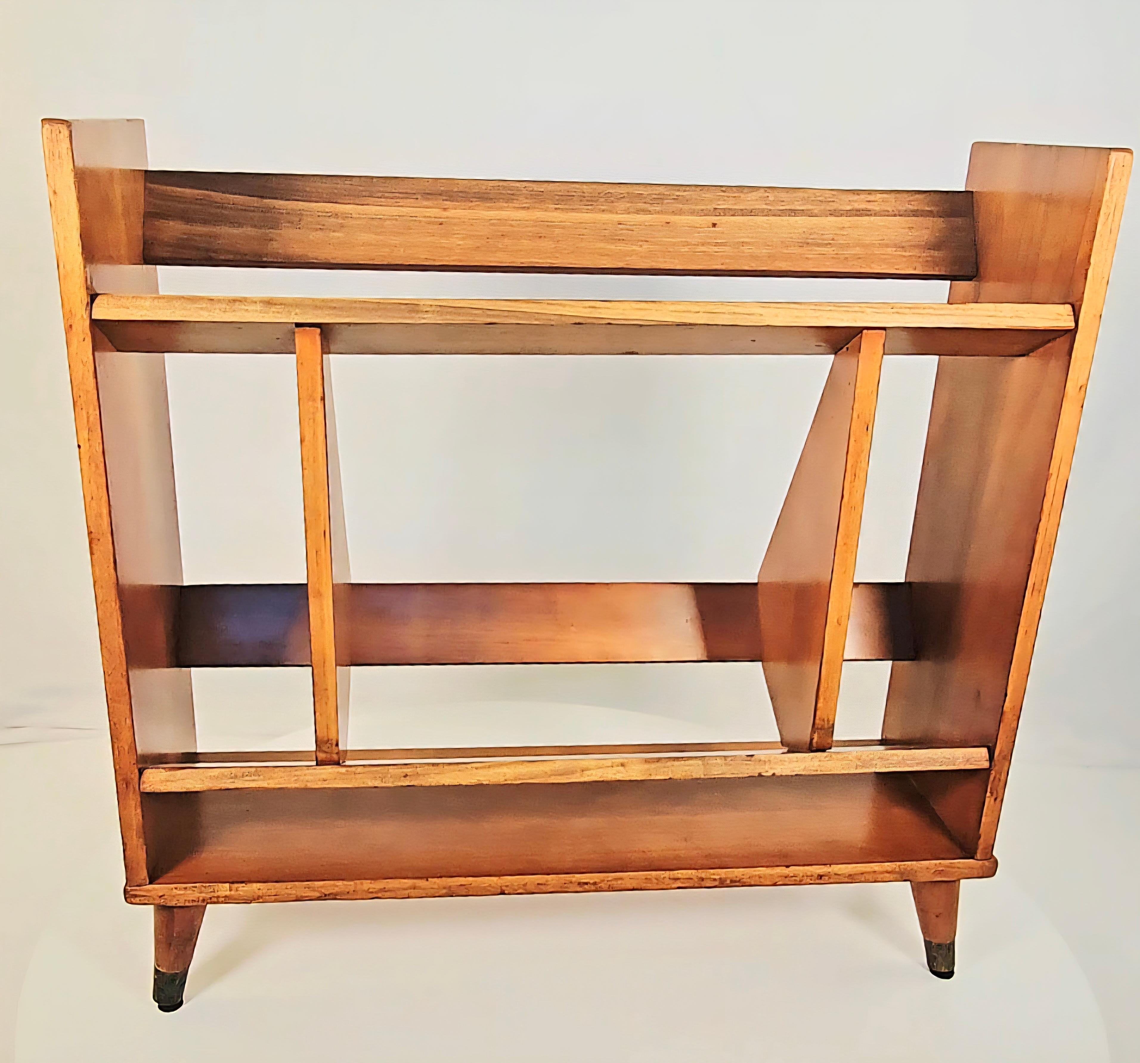 Small walnut open book shelf clearly executed by a fan of Gio Ponti and his designs for the University of Padua, with its asymmetrical structure and half-harlequin motif. Tapered legs with brass capped feet. Ideal book size is a National Geographic