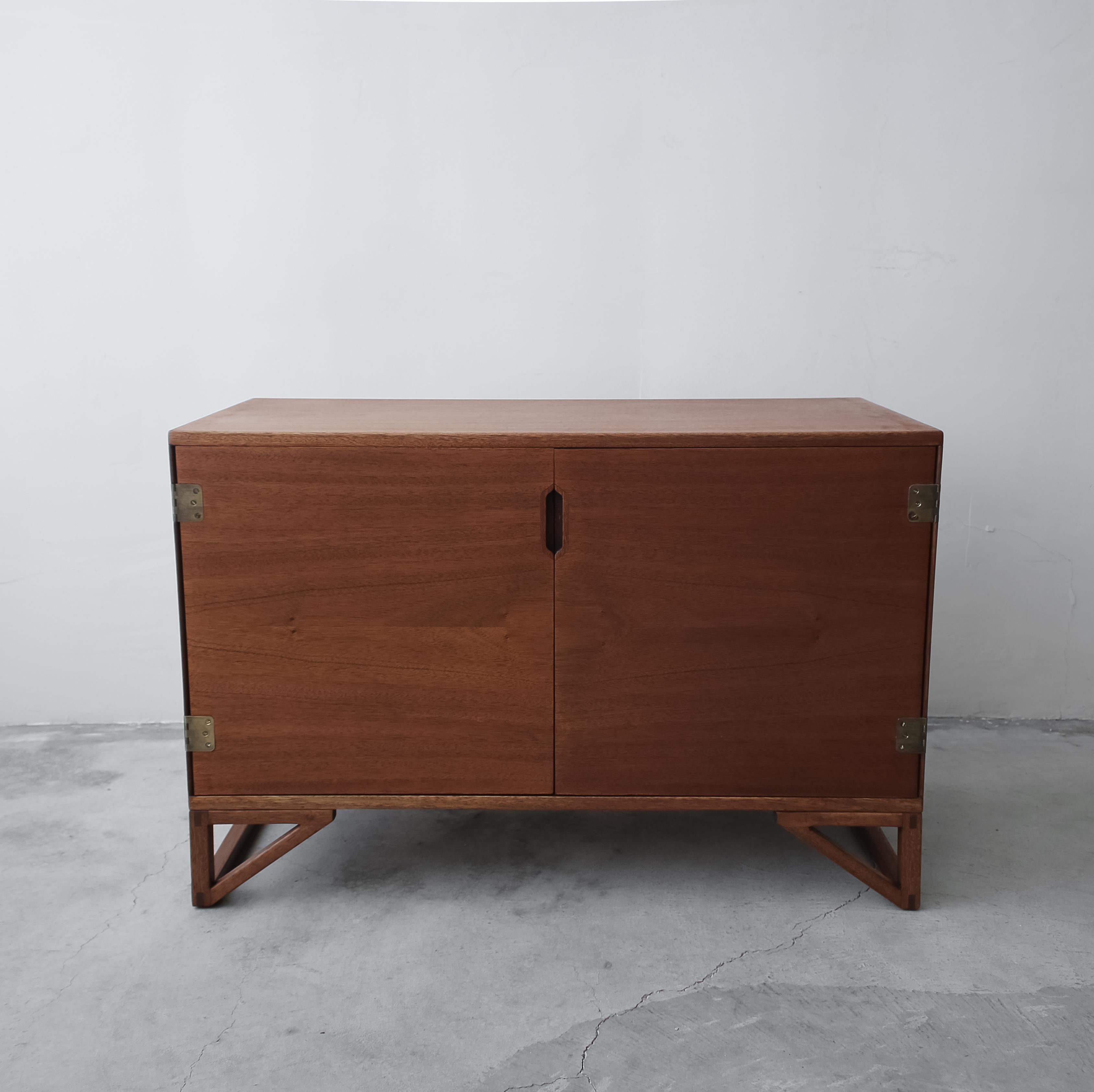 Simple, petite Danish credenza by Svend Langkilde. Simply clean lines and small size make it perfect for and small space that needs a bit of hidden storage.

Credenza is in overall good vintage condition. The back has been painted green and there