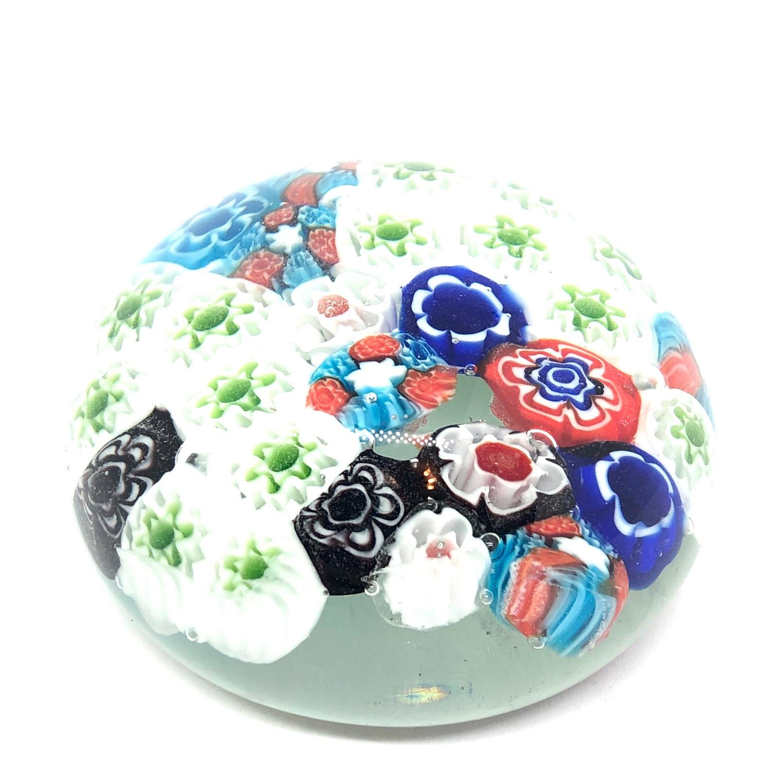 Beautiful Murano hand blown Italian art glass paper weight. Showing some flowers. Colors are a blue, white, green and clear. A beautiful nice addition to your desktop or as a decorative piece in every room.
