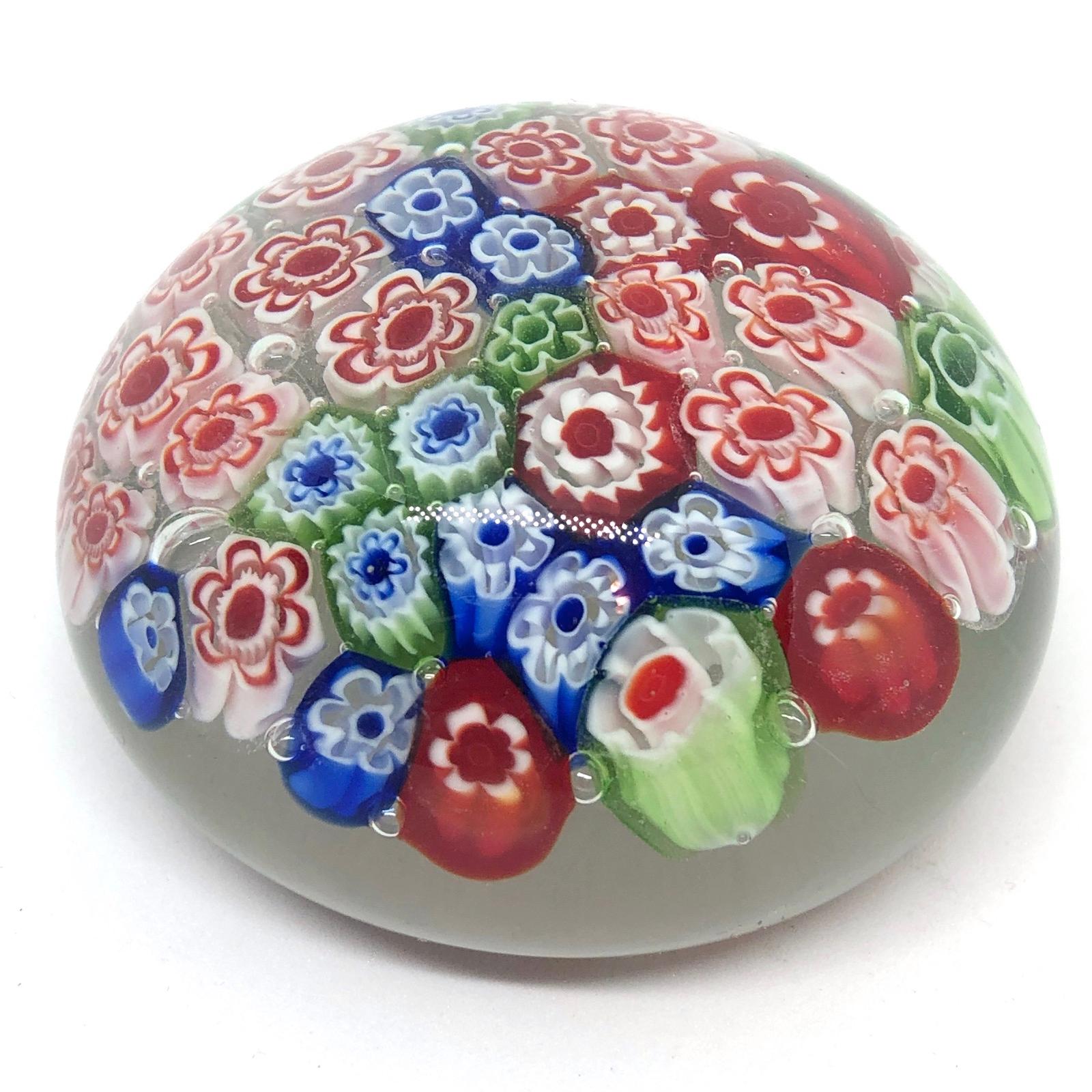 Beautiful Murano hand blown Italian art glass paper weight. Showing some flowers. Colors are a blue, white, green and clear. A beautiful nice addition to your desktop or as a decorative piece in every room.