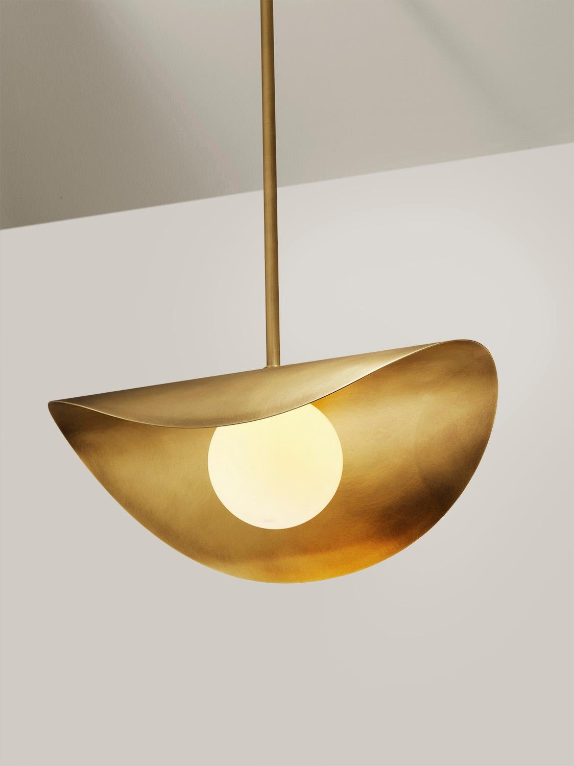 Introducing the Petite Montera, a charming rendition of our beloved Montera pendant, scaled down for a more intimate ambiance. Crafted with the same organic flair, its undulating, biomorphic form gracefully crowns a petite blown satin glass globe.