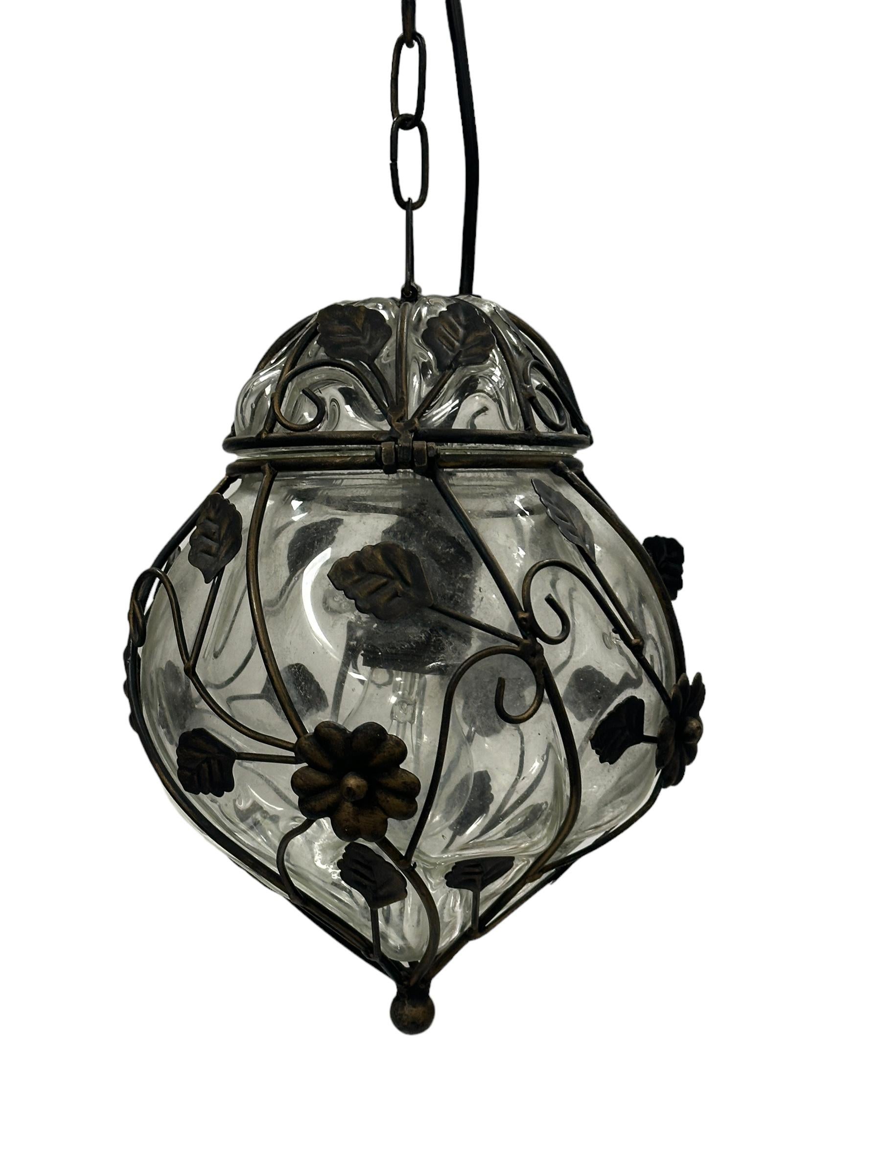 Gorgeous petite Pendant in bubble-wrapped Murano glass with cage. The glass is hand-blown with an clear tint and was created by a murano manufacturer during the 1960s in Italy.

This Murano glass bubble cage pendant with oriental style and a 