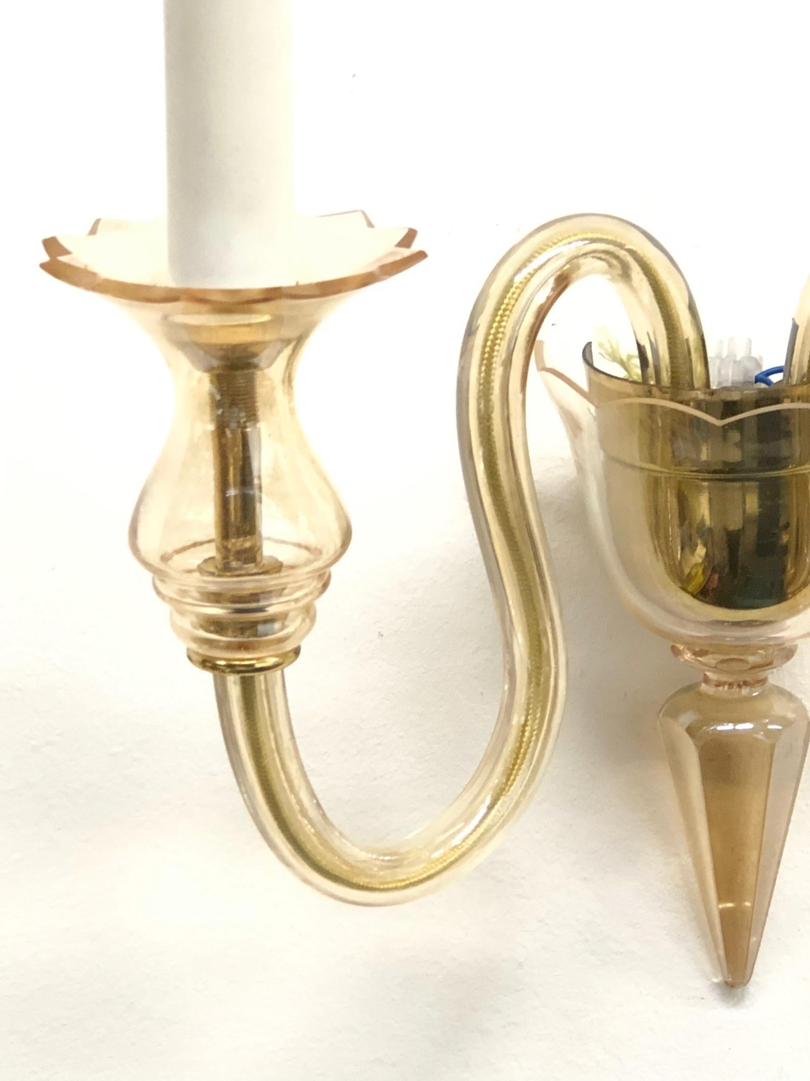 This Hollywood Regency style sconce is made of Murano glass, it has two arms with bulb holders. The fixture requires two European E14 candelabra bulbs, each bulb up to 40 watts. Bulbs are not included in this listing.