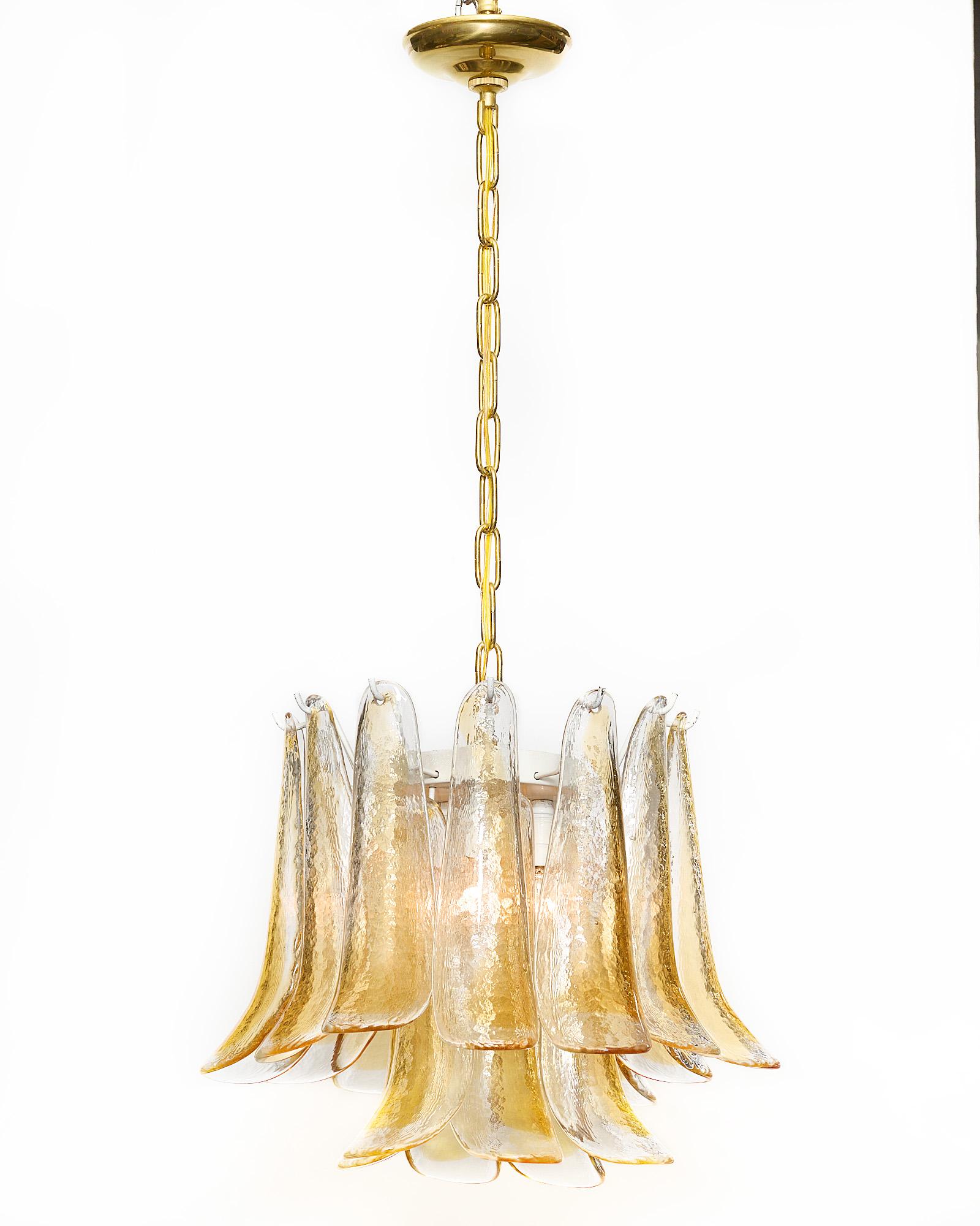 Chandelier, Italian, from the island of Murano. Each hand-blown glass component is in the “selle” or shoehorn shape with amber and textured clear glass. It has been newly wired to fit US standards.
Current height from ceiling is 36”.
