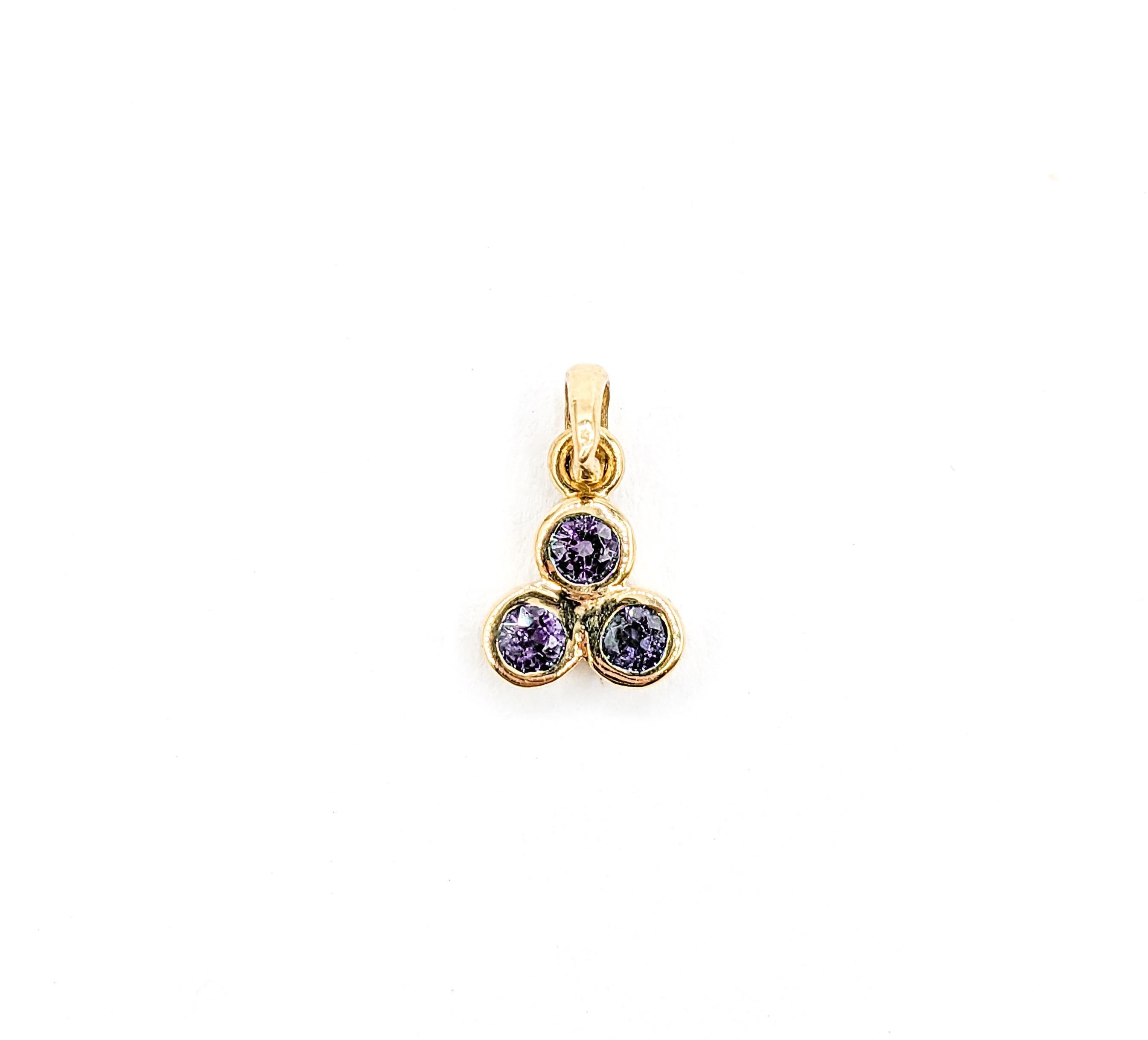 Petite Natural Alexandrite Pendant Charm in Yellow Gold 

Introducing this delicate pendant, a stunning creation in 14k yellow gold. At its heart are three bezel set stones, totaling .20ctw of natural Brazilian Alexandrite, each gem sparkling with a