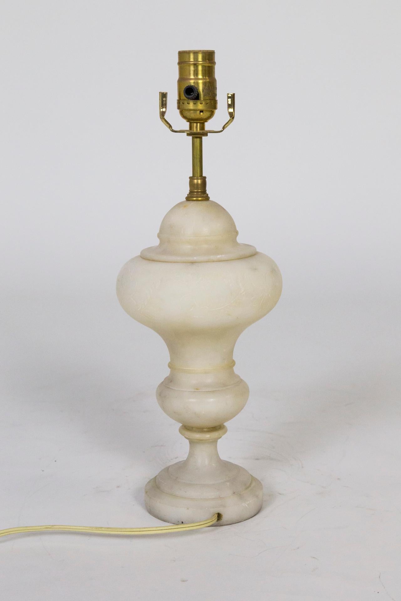 An alabaster, urn shaped lamp with subtle, simple, carved line flowers. An elegant piece, small in size - very nice for an end table or bedside table. Measures: 16