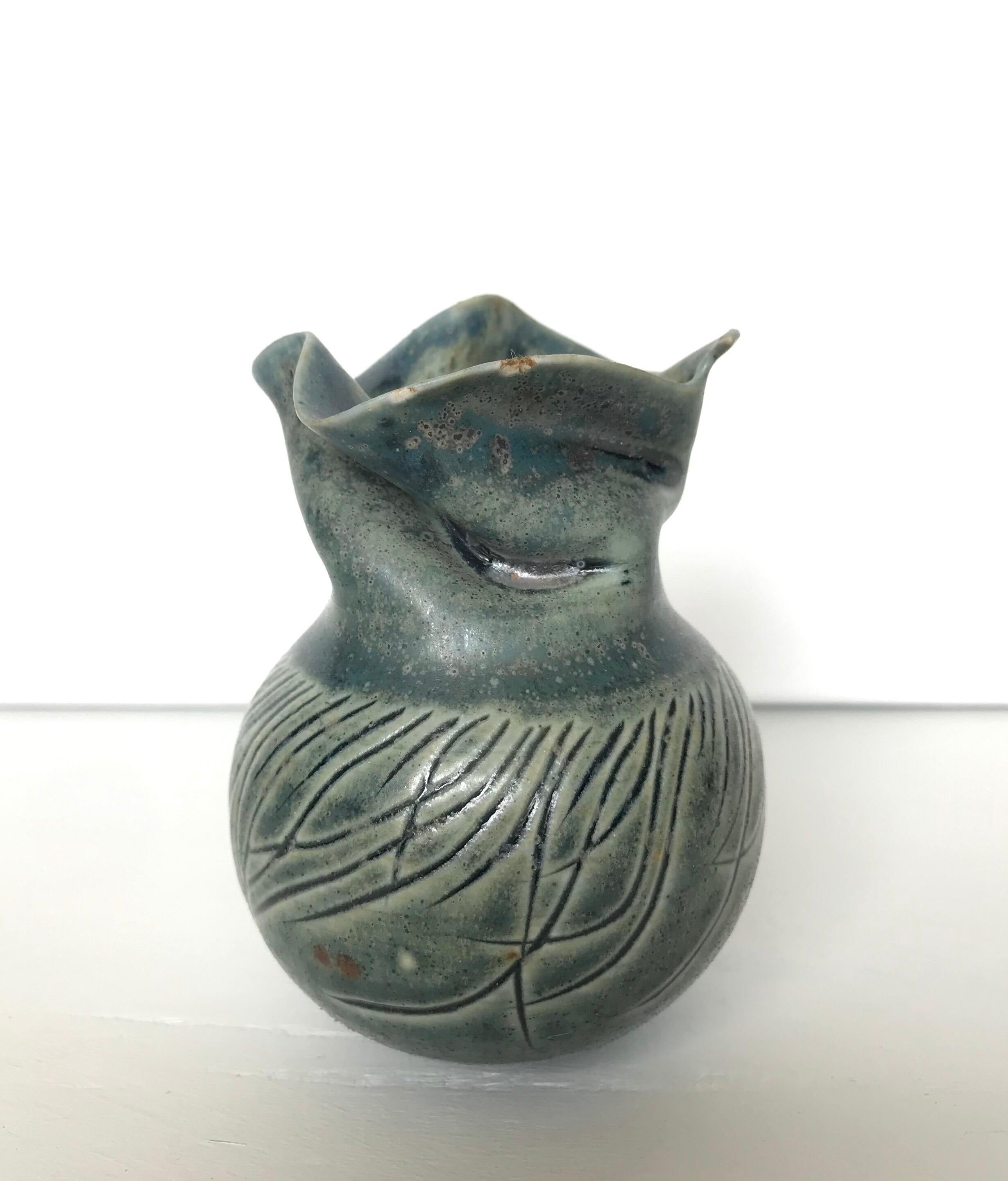 A wonderfully crafted Studio Pottery vase by American ceramic artist Scott Malcolm. Malcolm is known for his pale celadon palette and technique of throwing the piece and then doing gorgeous hand shaping and tooling of the form to give it extra