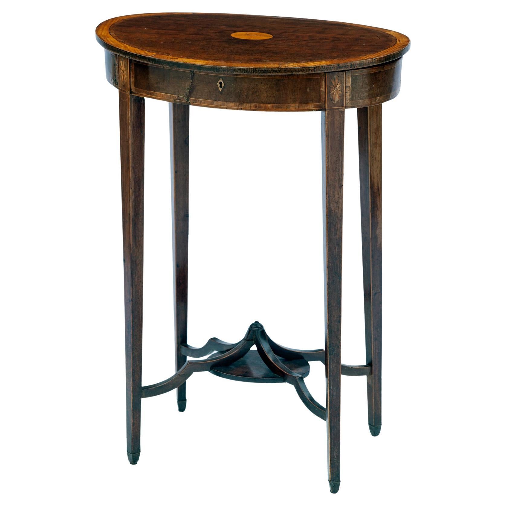 Elegant accent table with tapered square legs, unique stretchers, inlaid banding & faux drawer. Beautiful French polished finish.
Top is slightly bowed.
