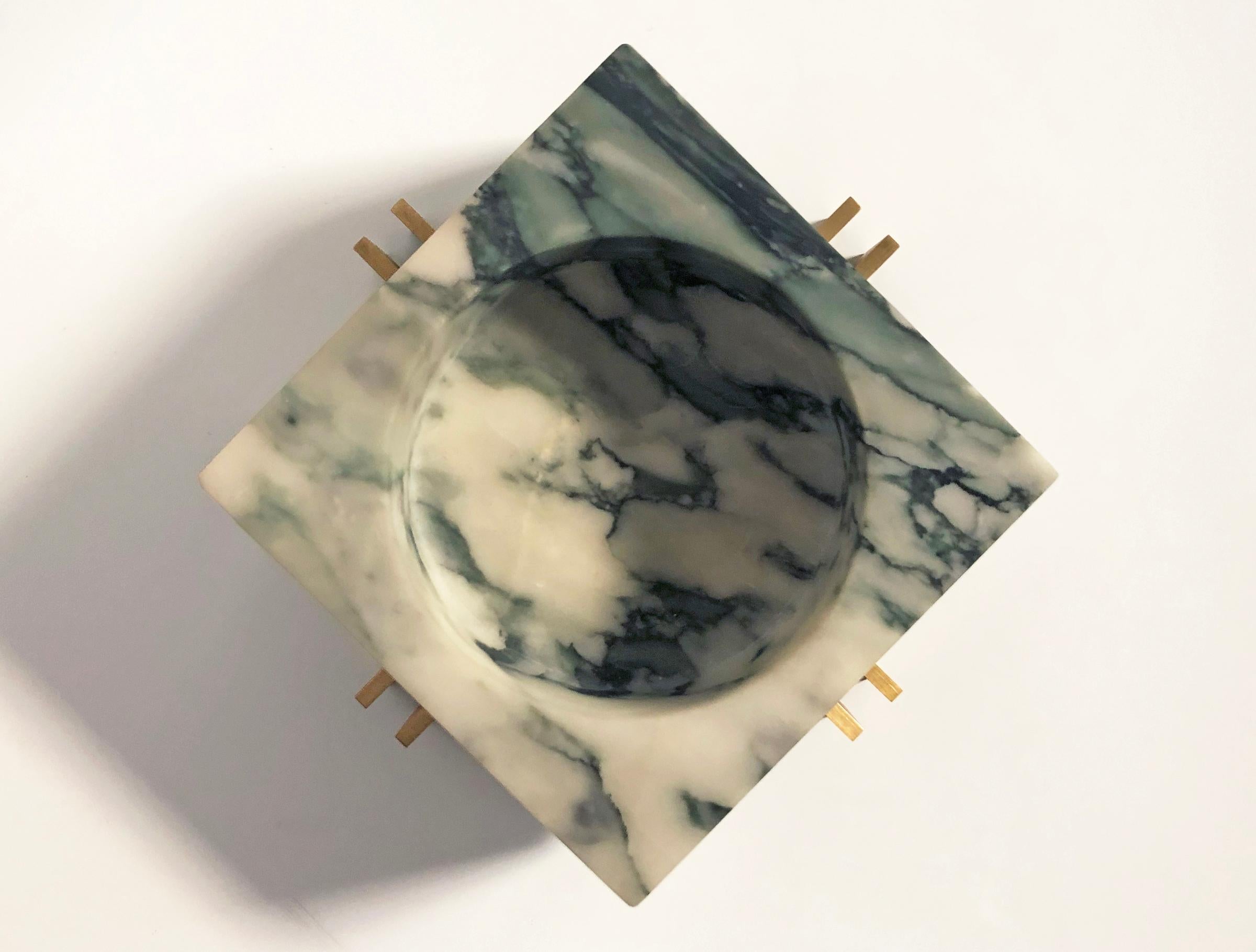 Brushed brass plate and Fiori marble unite in this petite version of our parallel bowl.
The marble bowl nestles within the brass base and are two separate pieces.
The brass has been rubbed with a crystalline wax.


Dimensions of base: 19 x 19 x
