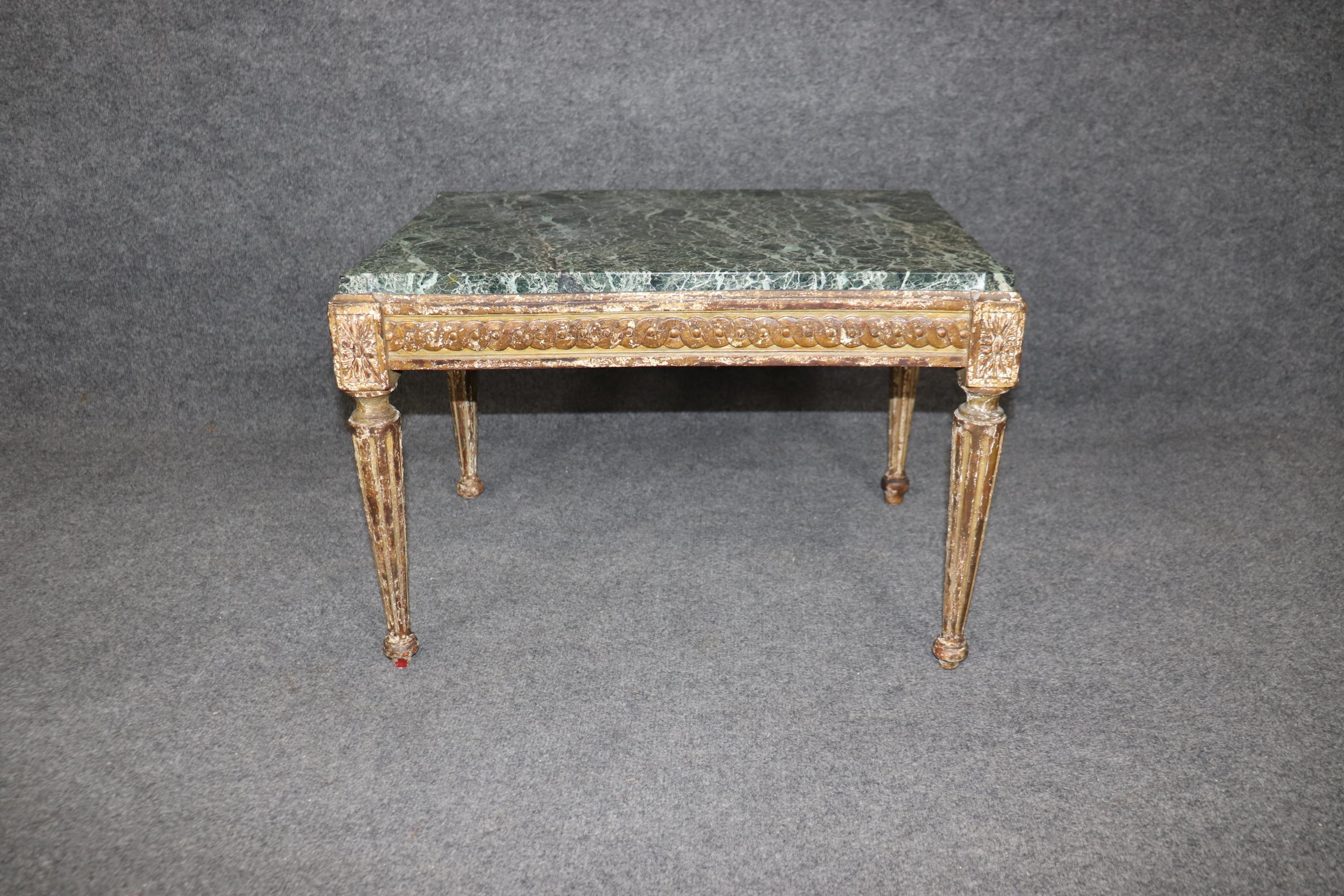This is a gorgeous petite table that looks like a small coffee table and may have served that purpose. The table is beautifully distressed and carved with great patina and a gorgeous green marble top. The table is in good antique condition. Measures