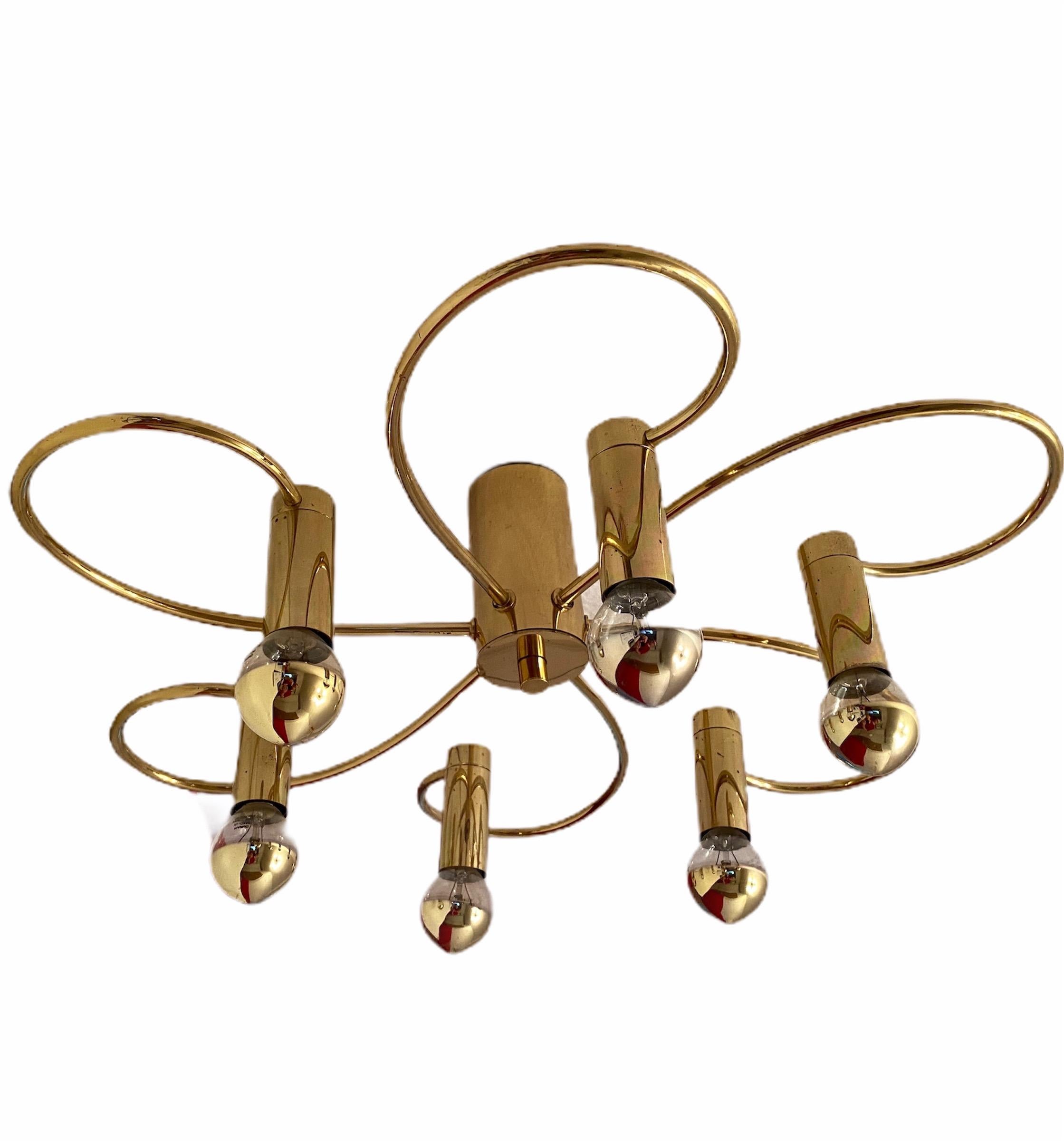 A gorgeous polished brass flush mount by Leola Leuchten. It can be used also as a wall light. The light fixture requires six European E14 light bulbs, each up to 40 watts. It measures approximate: 6 3/4