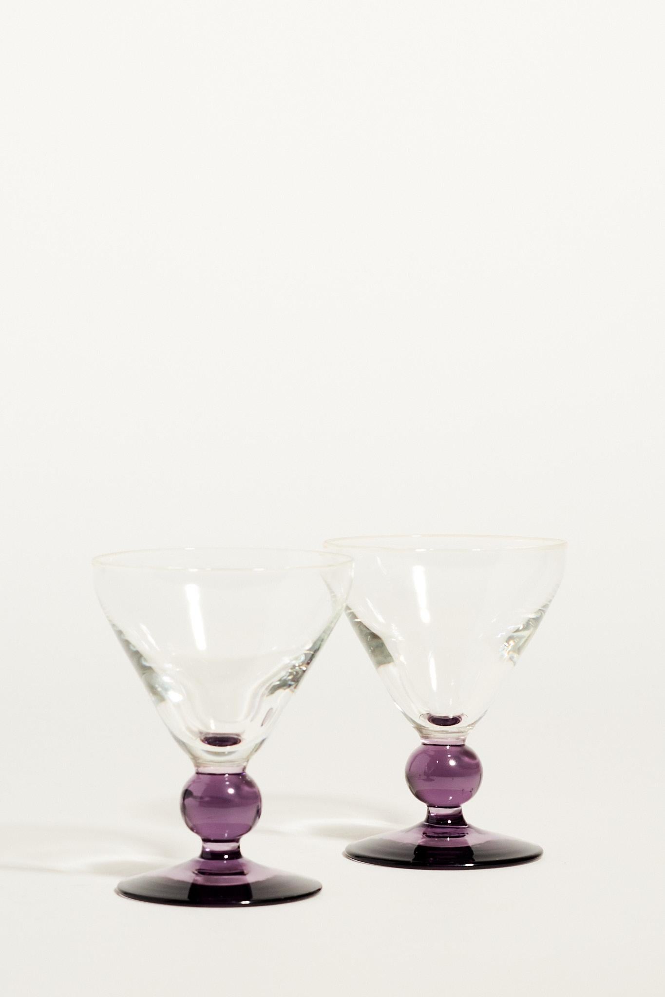 Petite cocktail glasses with deep purple ball stem and transparent glass.