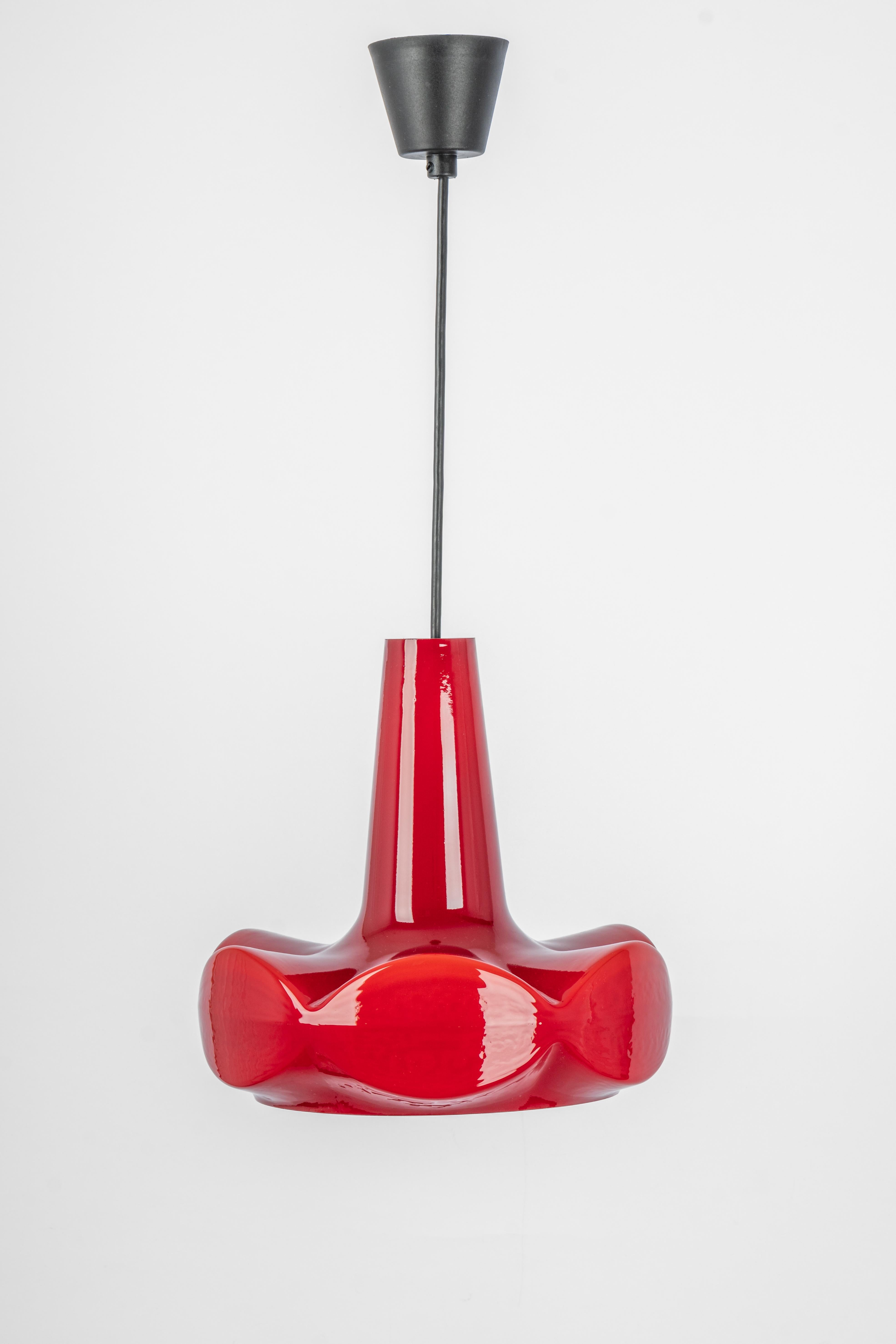 Petite Red glass pendant light by Peill & Putzler, manufactured in Germany, circa the 1970s.

High quality and in very good condition. Cleaned, well-wired, and ready to use. 
The fixture requires 1x E27 Standard bulbs with 100W max
Light bulbs