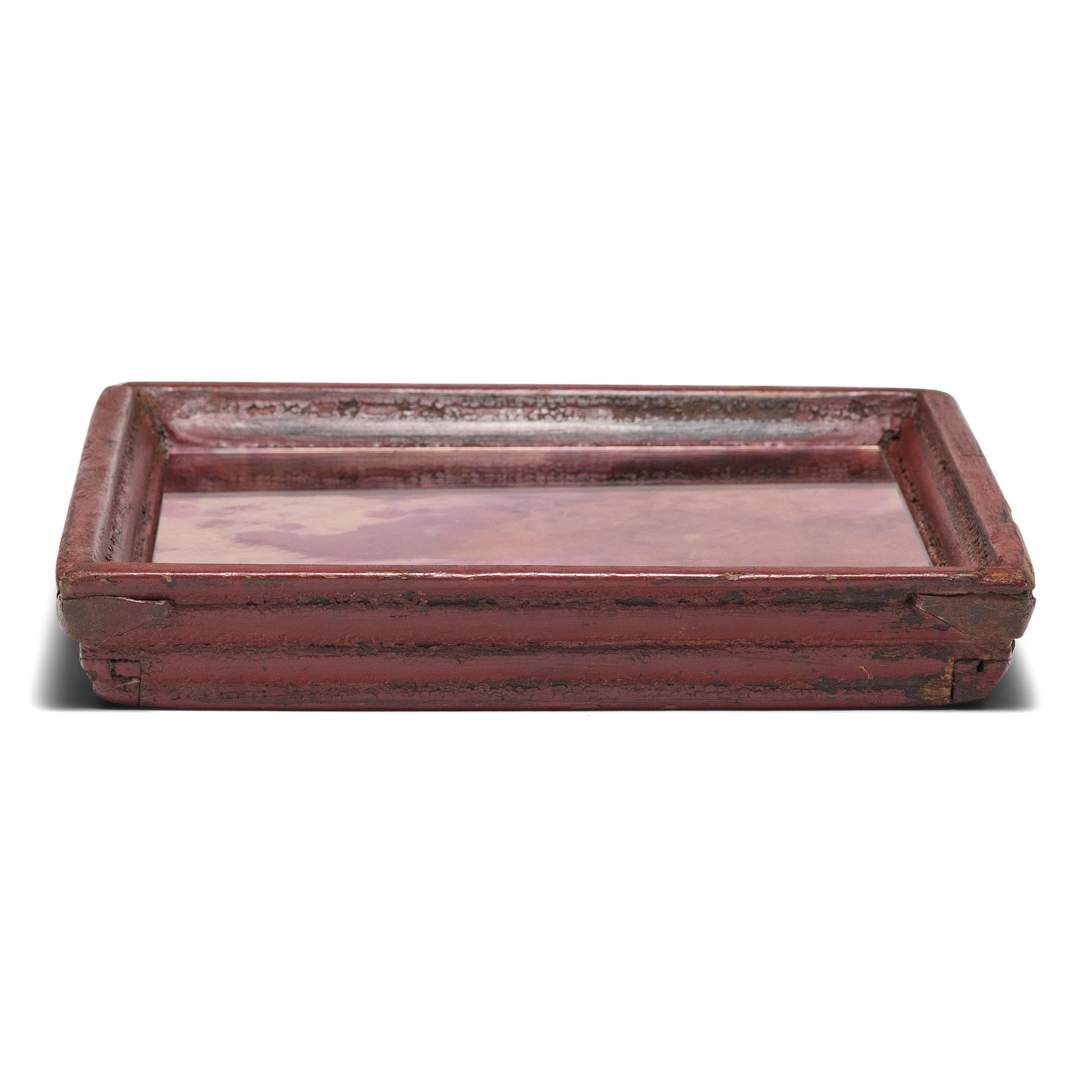 Simple lines, a modest form, and layers of hand-brushed red lacquer give this petite Qing-dynasty tray a timeless, provincial charm. The square tray has developed great character from years of use serving tea or food to friends and family gathered