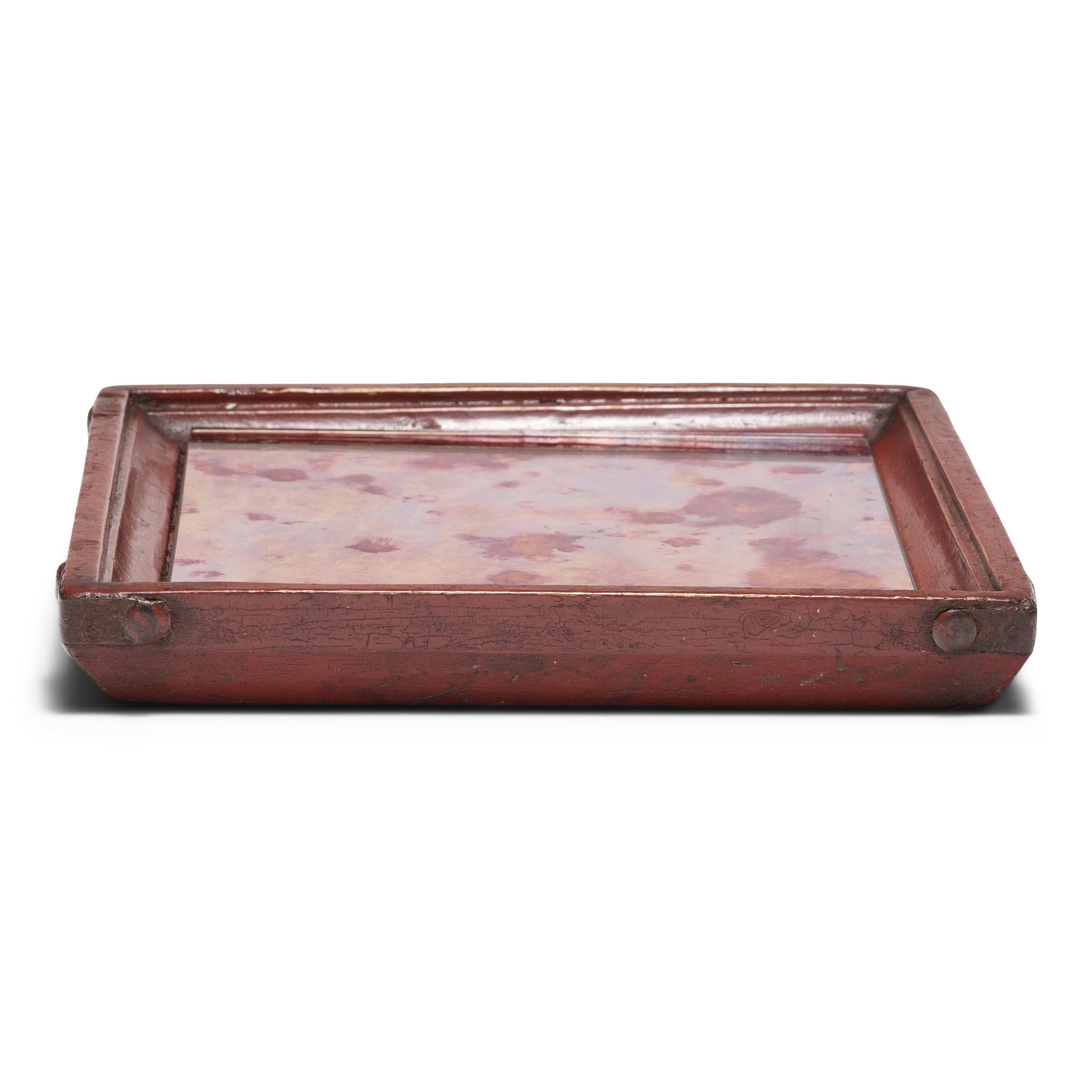 Simple lines, a modest form, and a layer of hand-brushed red lacquer give this petite Qing-dynasty tray a timeless, provincial charm. The square tray has developed great character from years of use serving tea or food to friends and family gathered