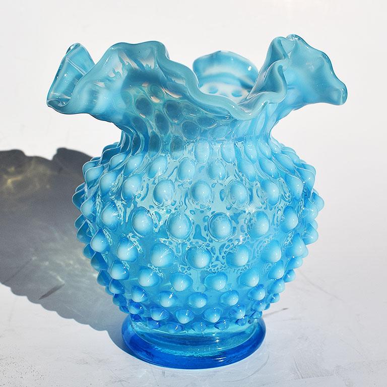 Beautiful blue round Murano style glass budded vase with raised hobnail bubbles. The raised bubbles are reminiscent of flowers that are on the verge of blooming. At the top, the edges are scalloped and ruffled and protrude outward in a wavy fashion.