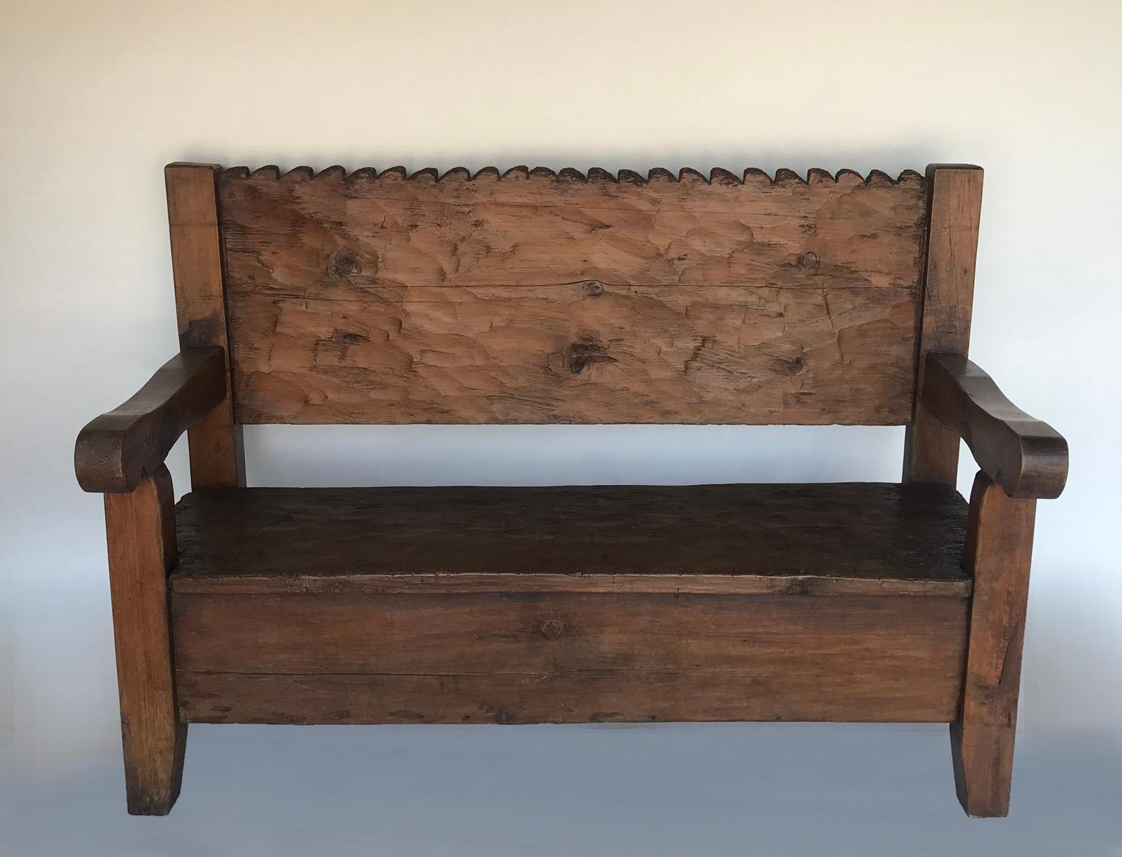Very sweet, petite, rustic Chajul bench from the highlands of Guatemala. The back and seat are both one wide boards traditionally hand hewn by machete. Bench back features scallops in a wave pattern.
Age appropriate wear throughout. Sturdy and