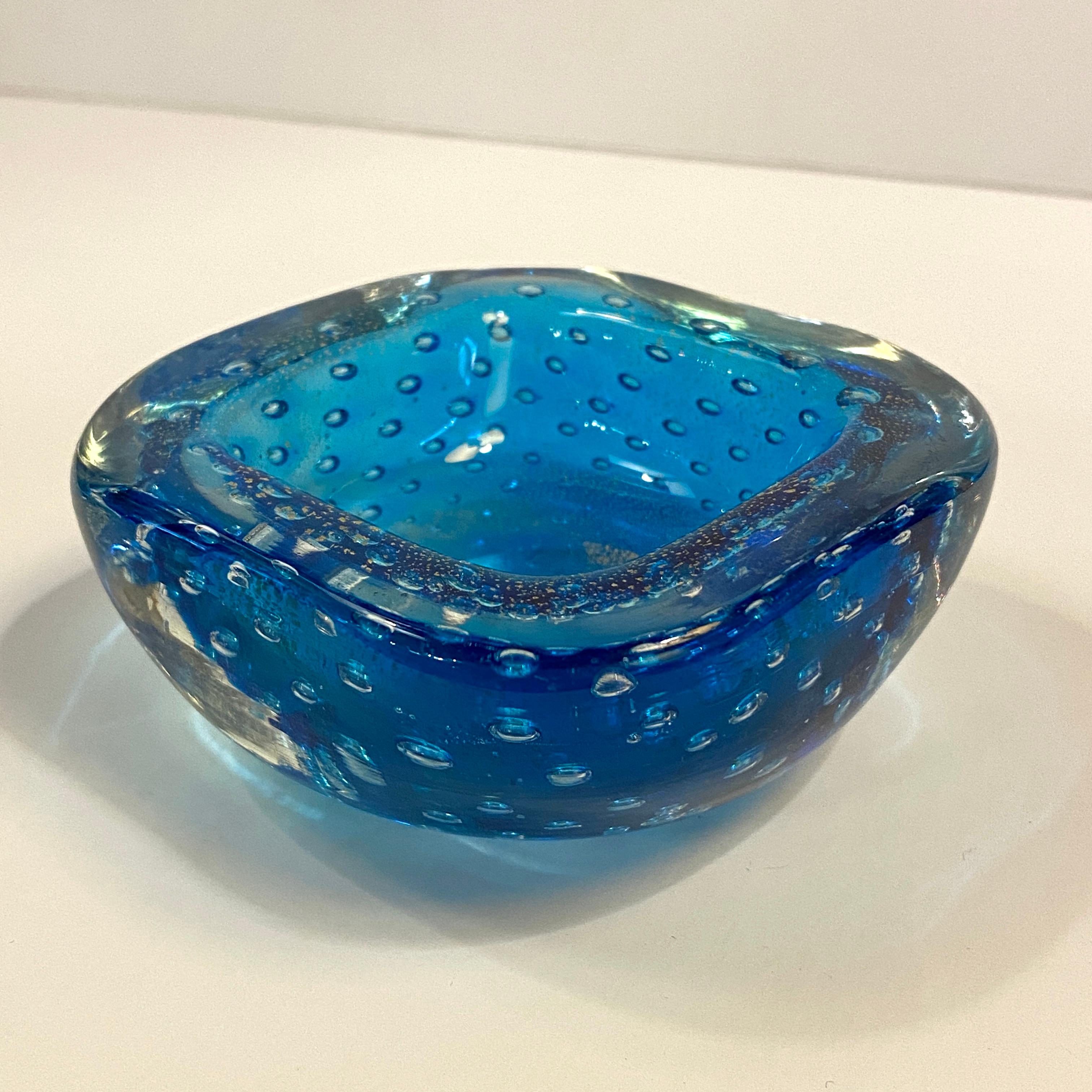Petite, midcentury modern, Italian Murano, sapphire blue, art glass dish features the controlled bubble technique called bullicante throughout with a gold fleck detail on the top surface. 