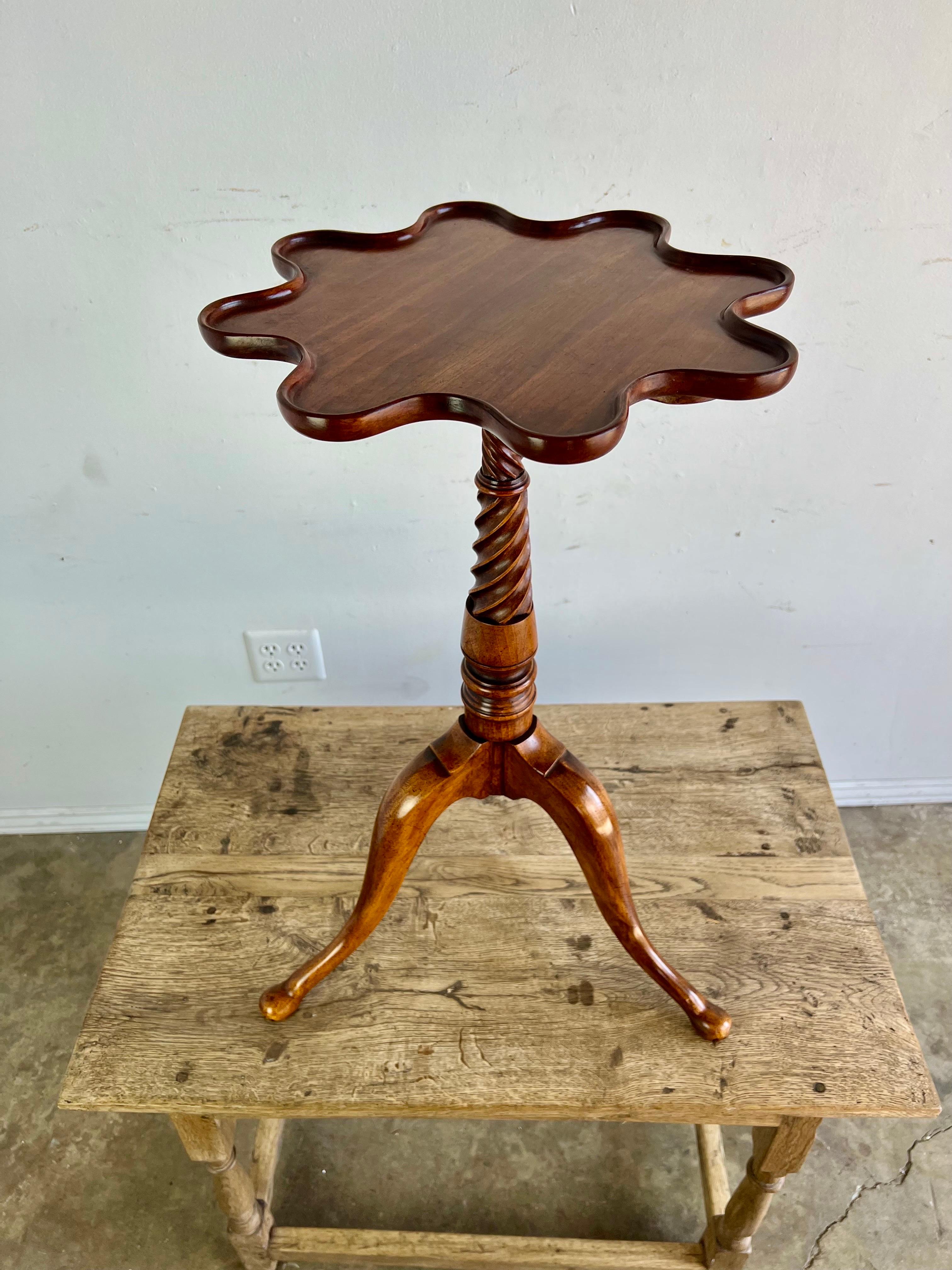 Petite Mahogany English tripod table with a twisted body and scalloped top.